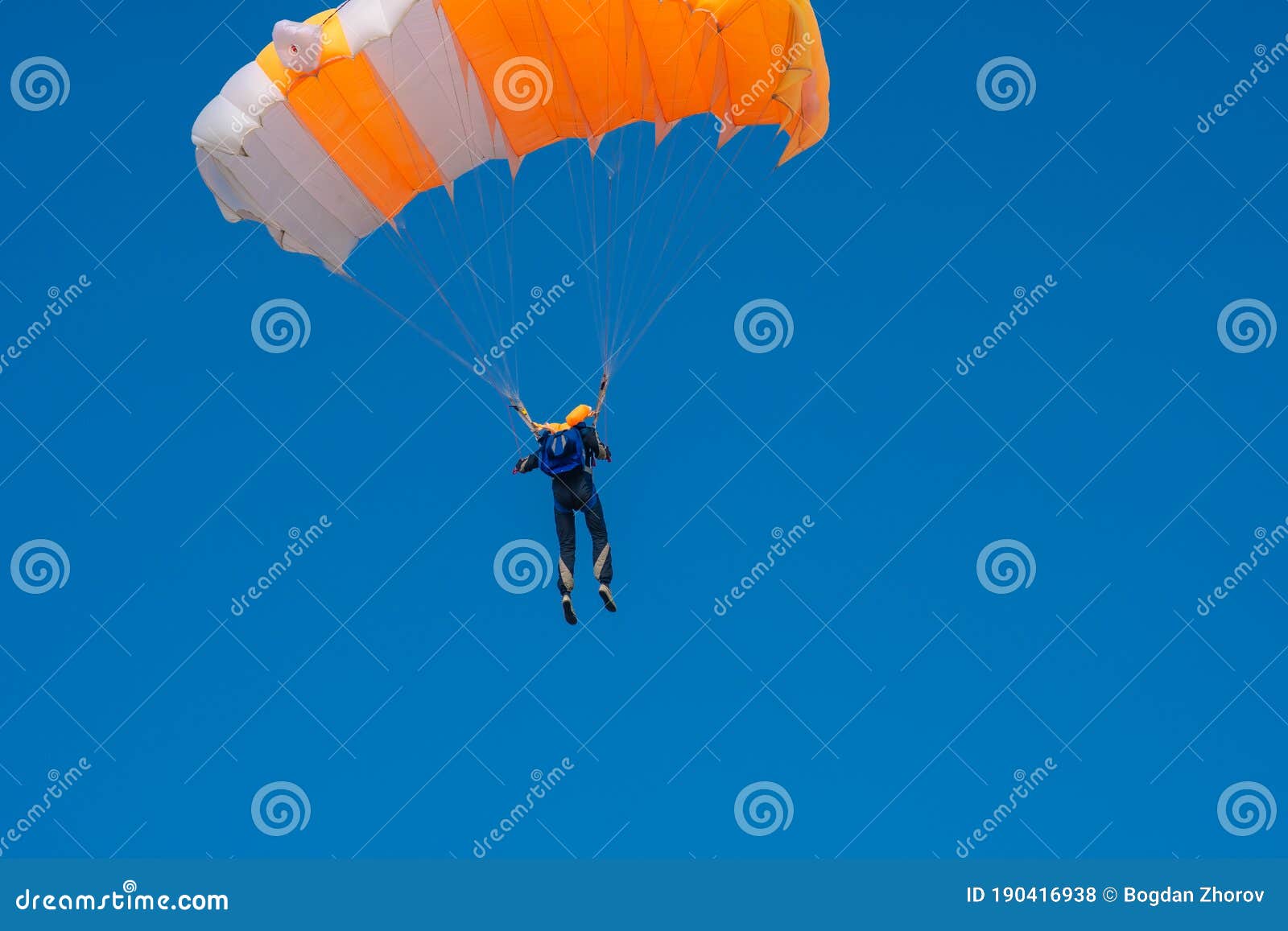 Skydiver is Flying with Parachute in Blue Sky Stock Photo Image of