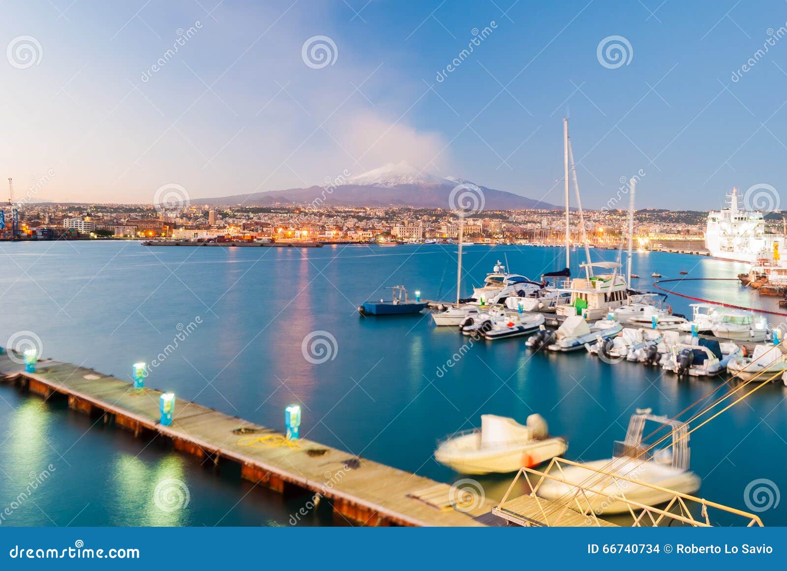 skyline of catania with snowy volcano etna in background