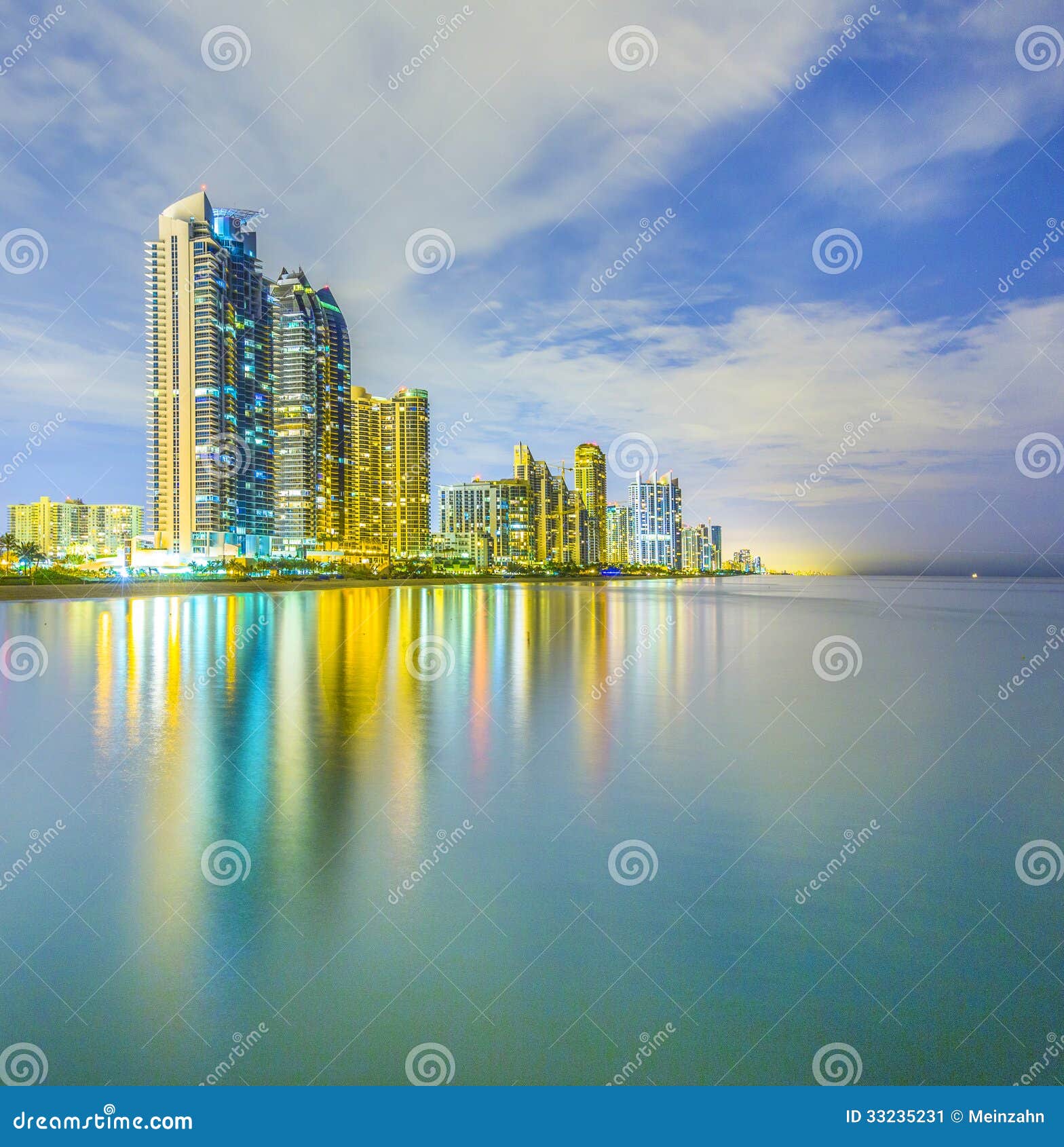 Skyline of Sunny Isles Beach by Night with Reflections at the Surface of the Ocean Stock Image
