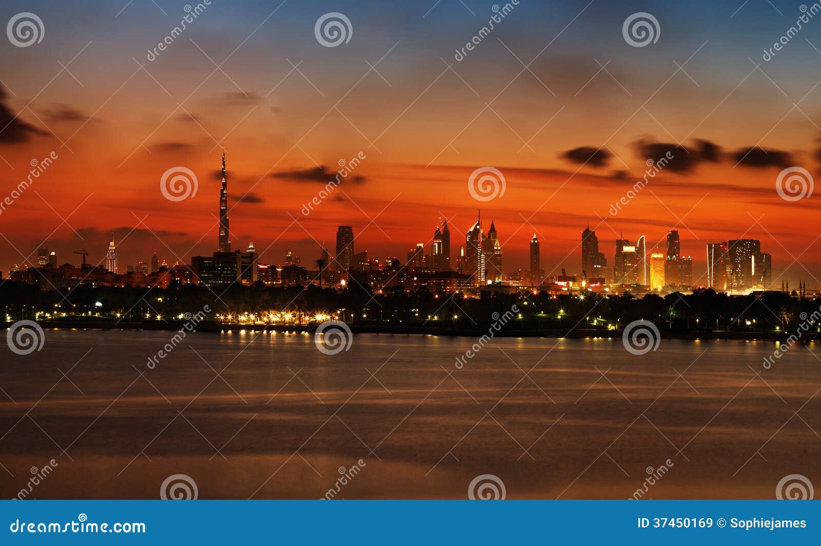 Skyline View Of Dubai At Sunset As Viewed From Across The Water Stock