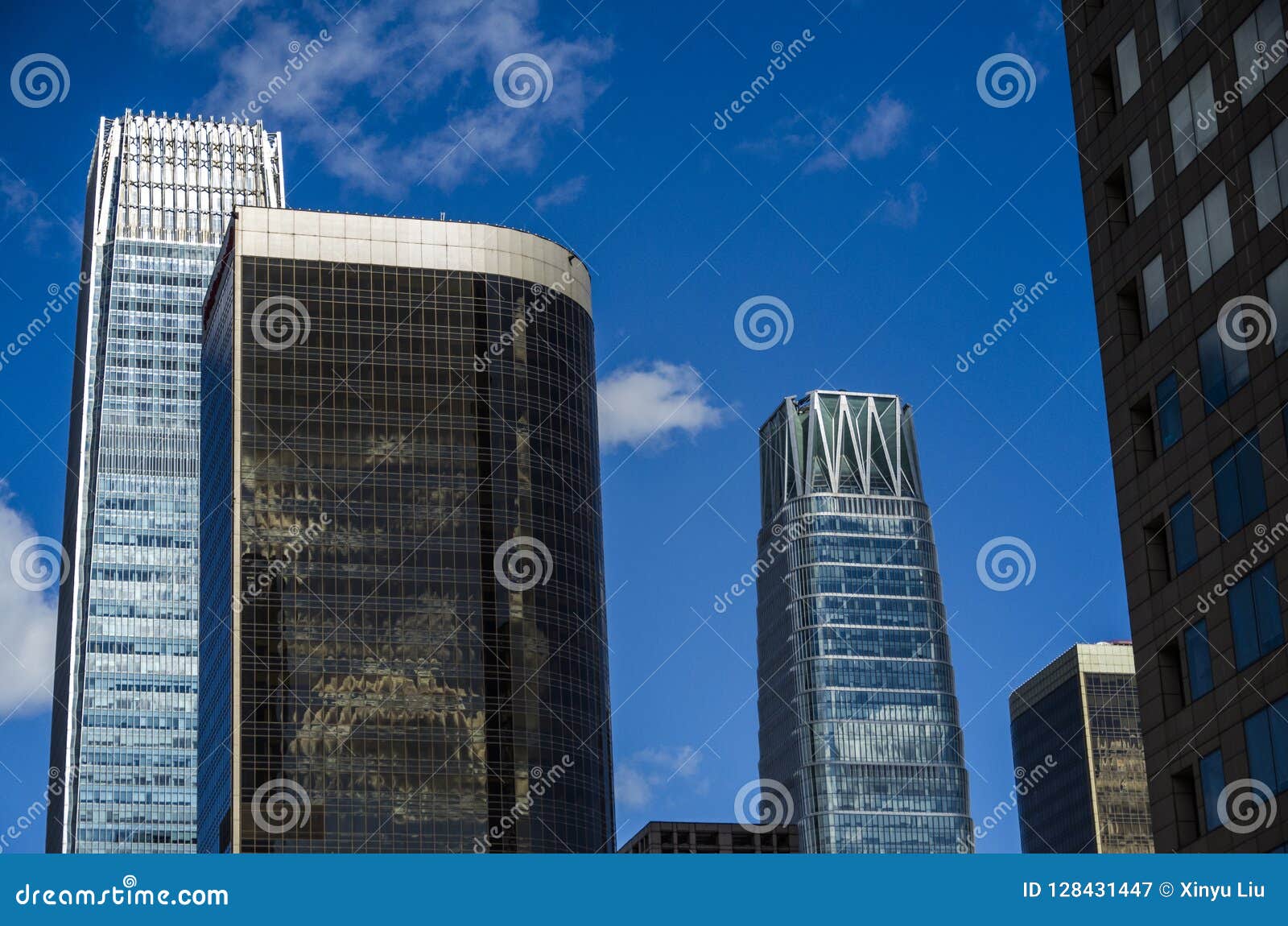 Skyscrapers with Blue Sky and White Cloud Stock Image - Image of glass : An astonishing photo capturing a gorgeous landscape. Its hues are vibrant and mix perfectly. The composition looks wonderful, with its features are extremely defined.