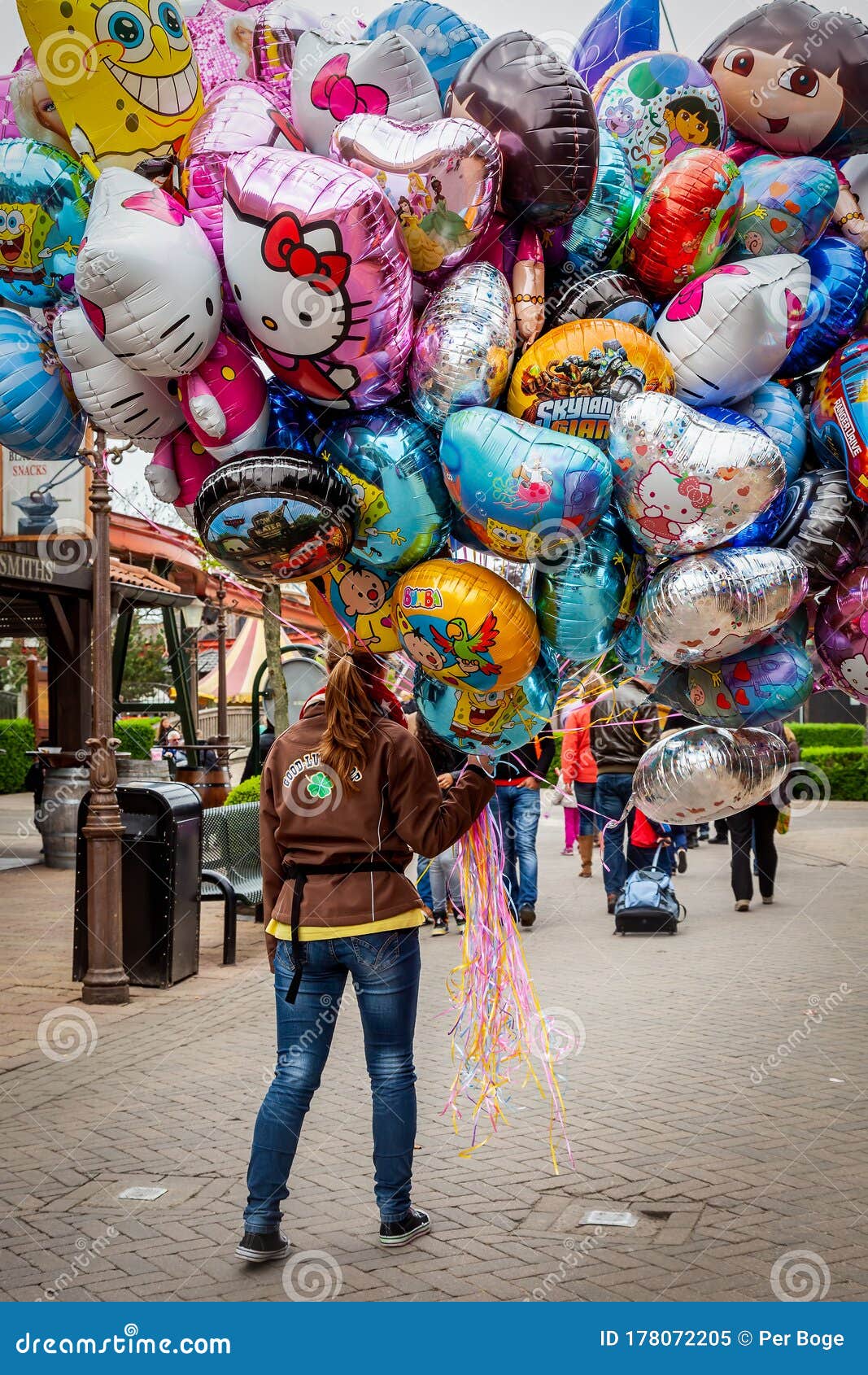 Woman Carrying Many Floating Gas Balloons with Different Cartoon Characters  Outdoors. Editorial Image - Image of people, amusement: 178072205