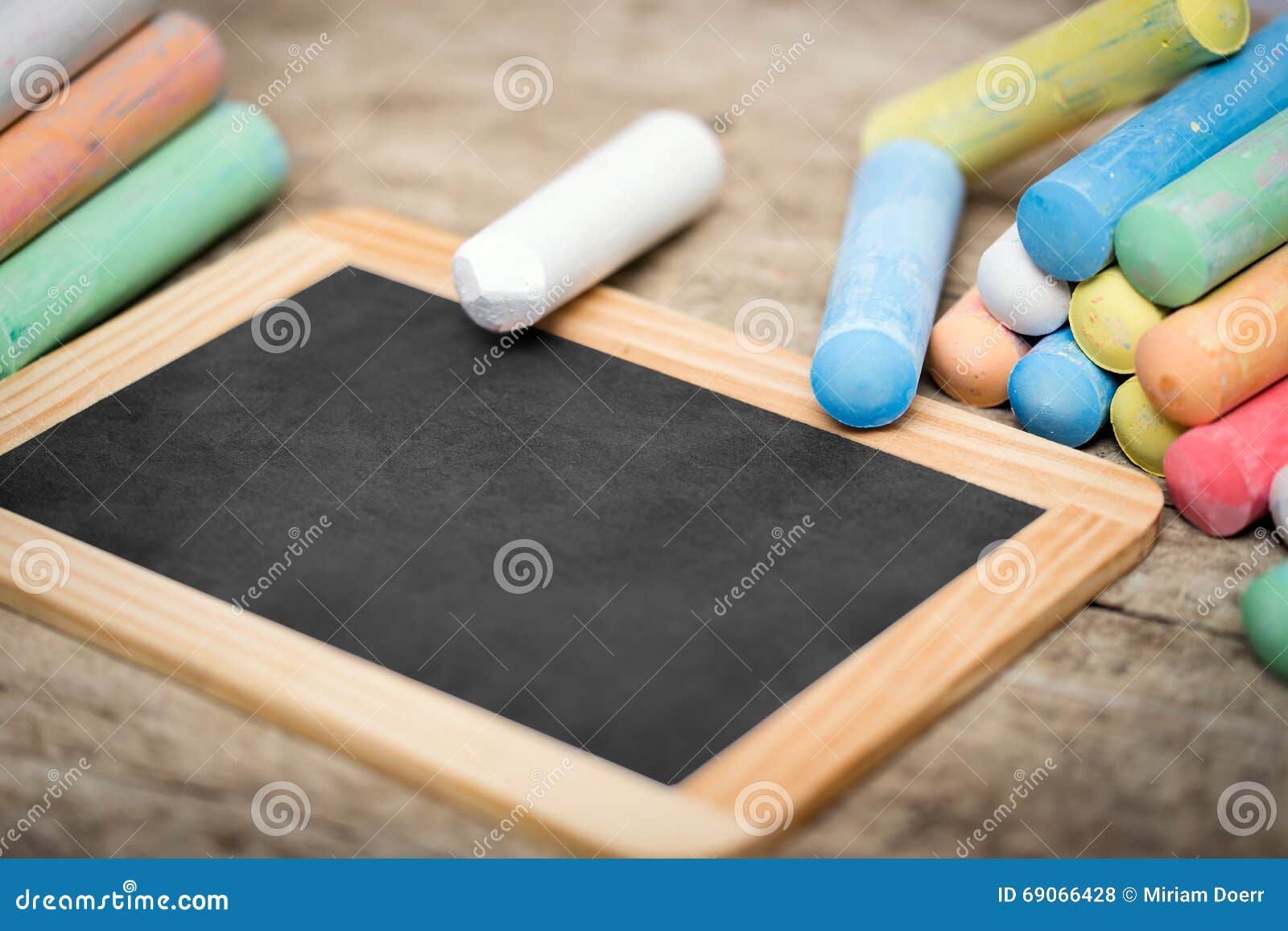 Slate with Copyspace and Colorful Crayon on Wooden Table Stock Photo