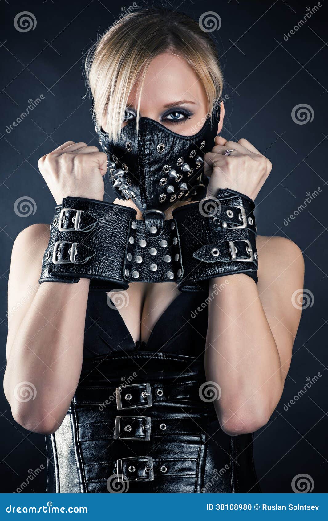 Girl in handcuffs and mask. in color lights. tied hands and