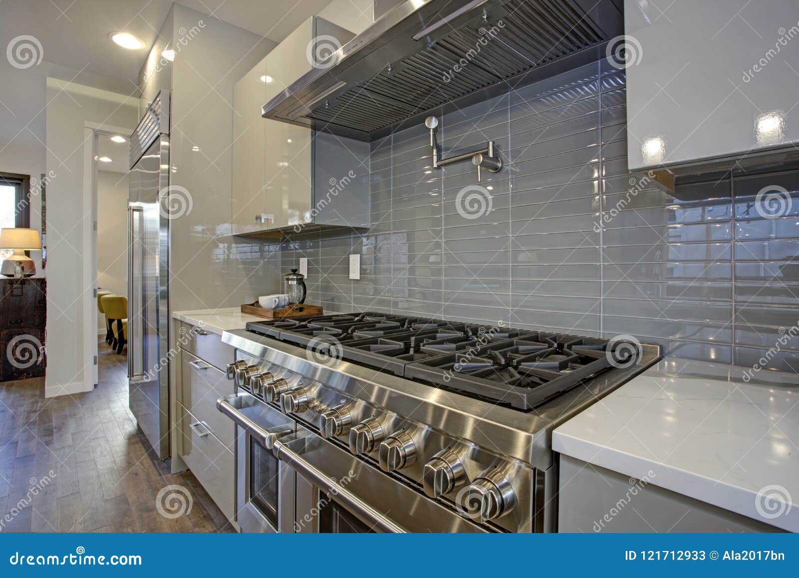 Sleek Modern Kitchen Design With A Glossy Gray Backsplash Stock