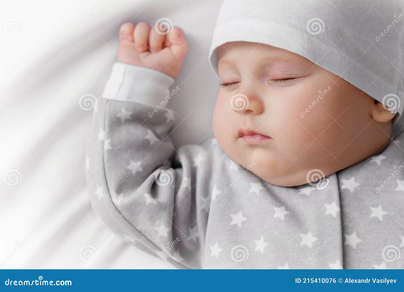 Sleeping baby in white bed stock photo. Image of carefree 215410076