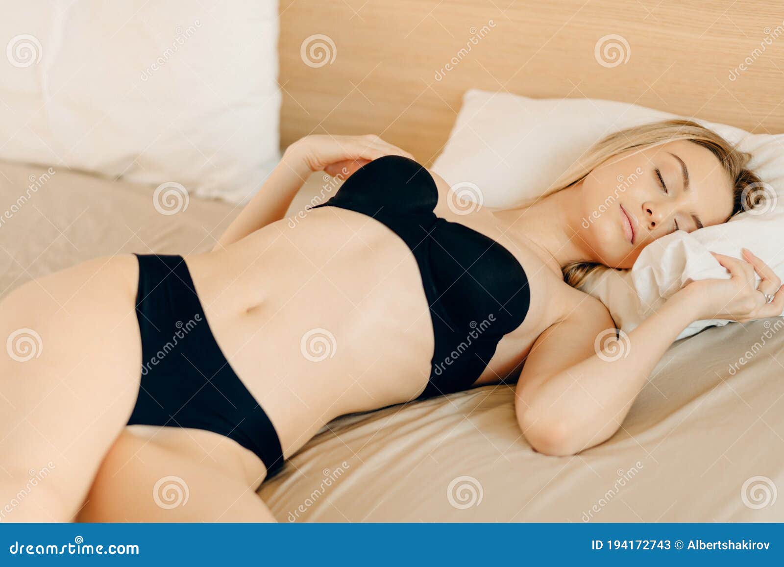 Beautiful Blonde Woman Posing On The Bed In Black Thong Panties