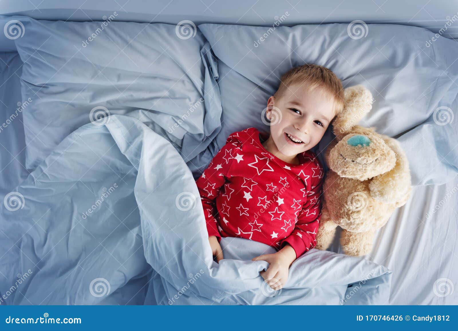 Sleepy Boy Lying In Bed With White Beddings Stock Photo Image Of