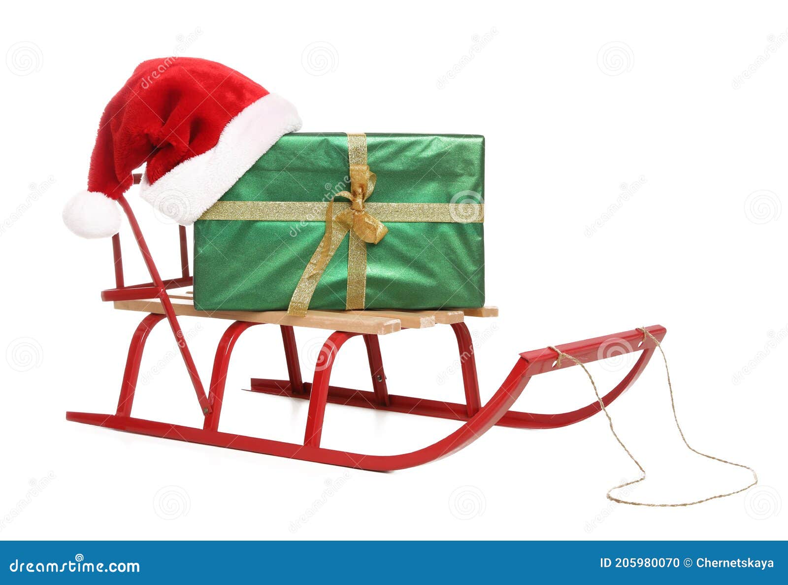 Sleigh with Green Gift Box and Santa Hat Isolated on White Stock Photo