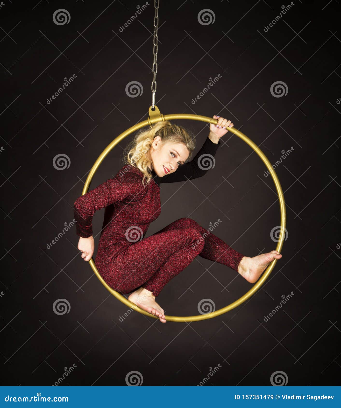slender blonde girl air acrobat red suit long hair performs exercises air ring slender blonde girl air 157351479