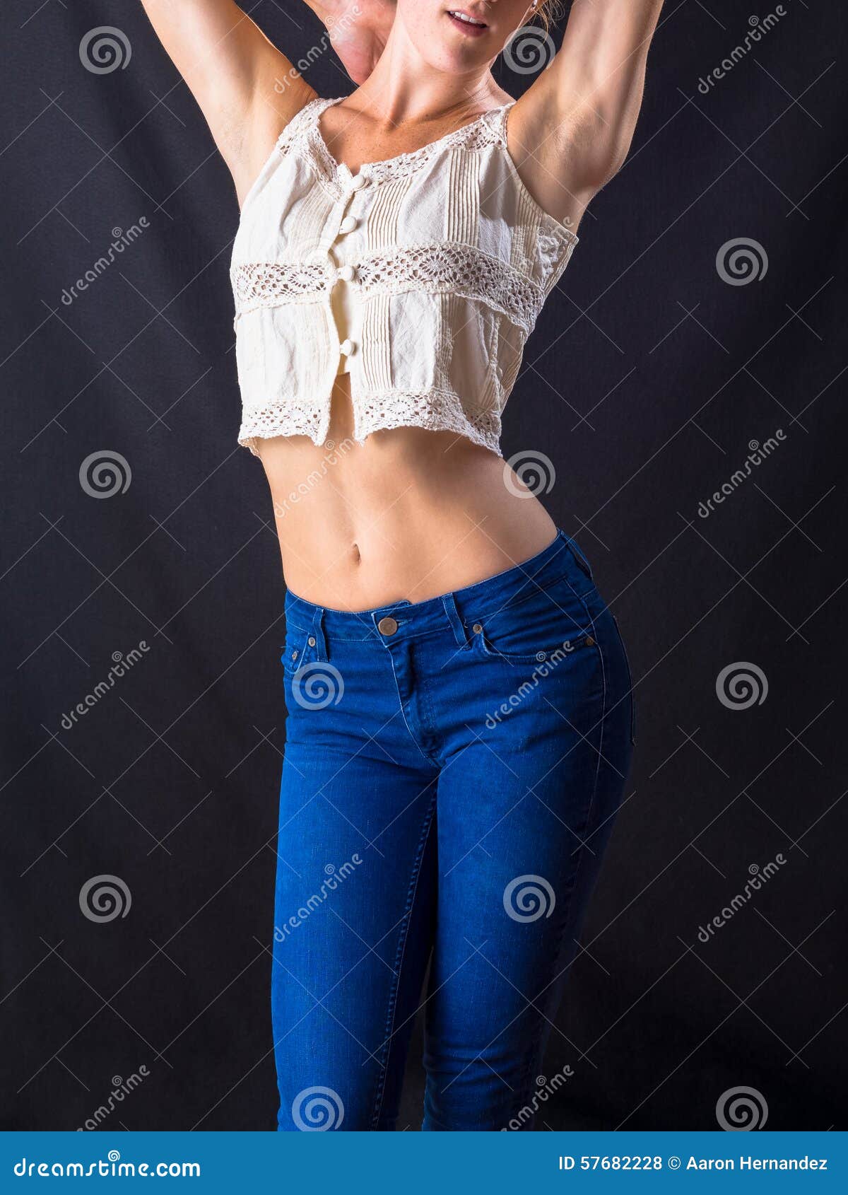 Attractive Young Pin Up Model Wearing Blue Jeans and a Crop Top