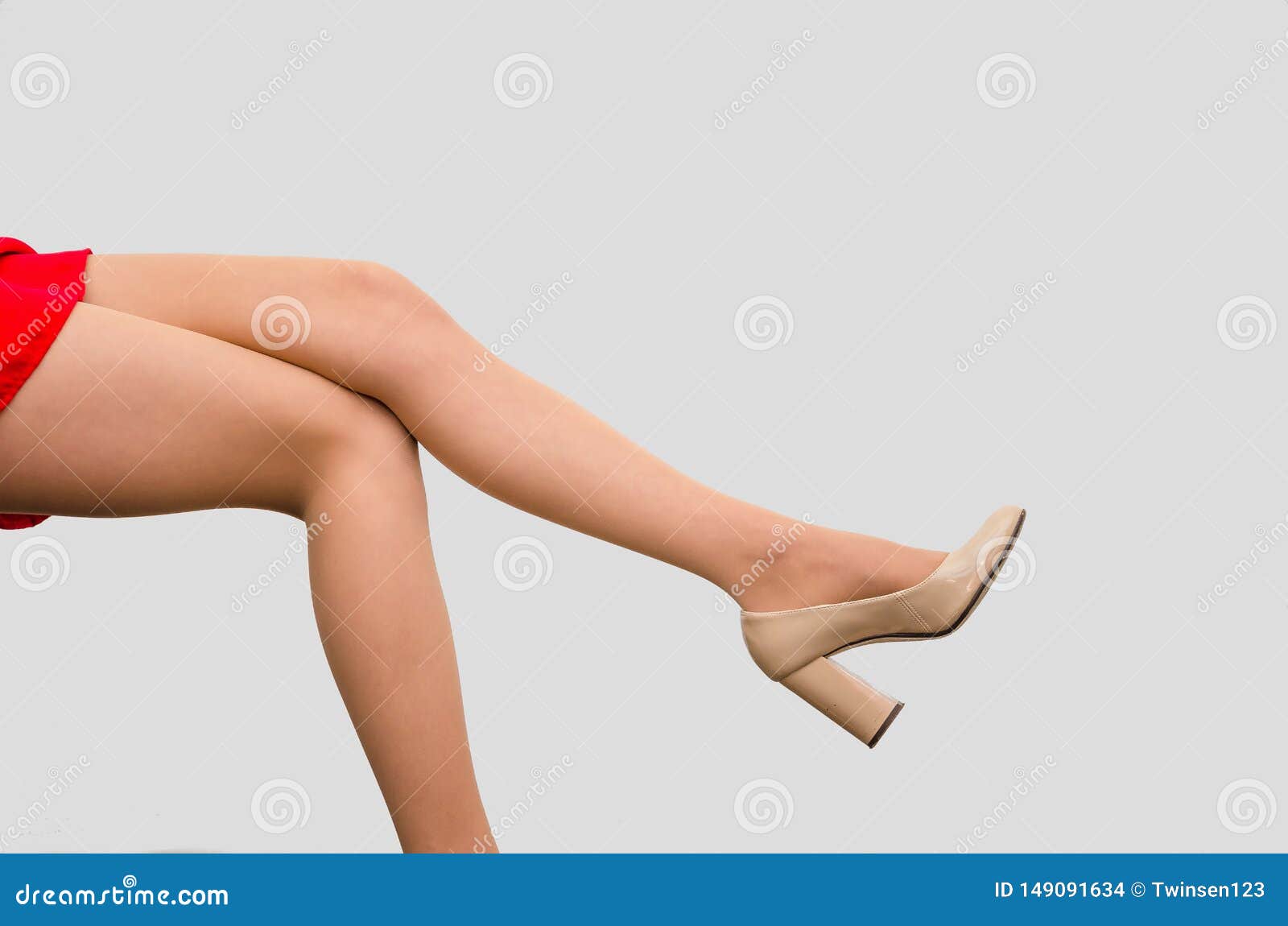 slender legs of a woman sitting on a chair. sexuality, seduction, women`s health
