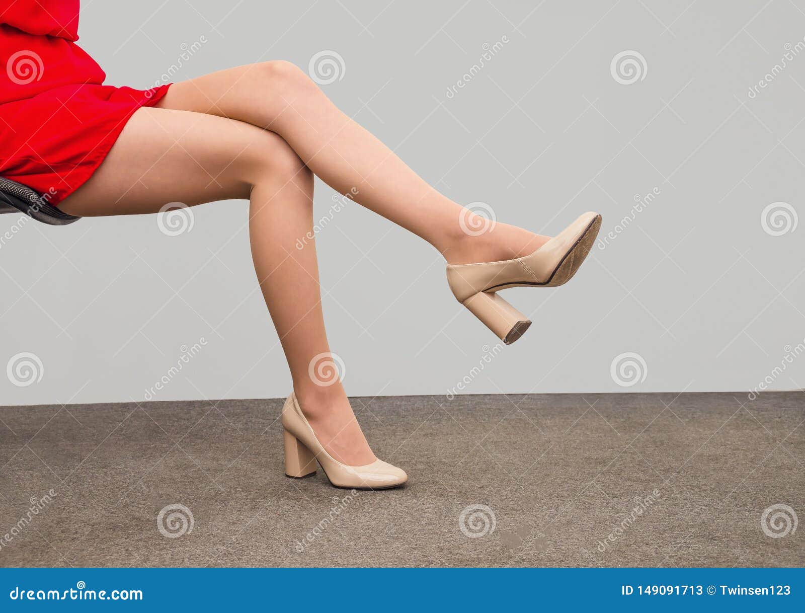 slender legs of a woman sitting on a chair. sexuality, seduction, women`s health