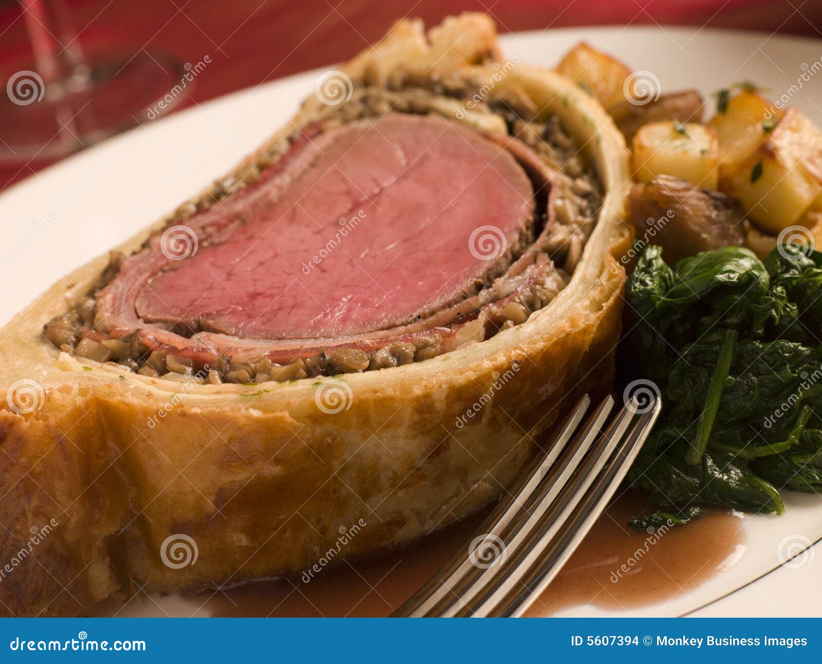 slice of beef wellington with spinach