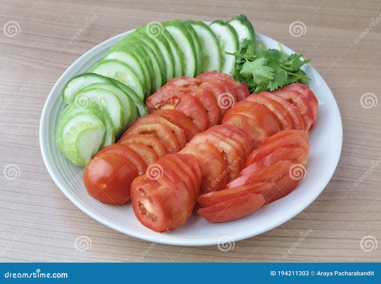 slice tomatoes, cucumbers with corianders on dish