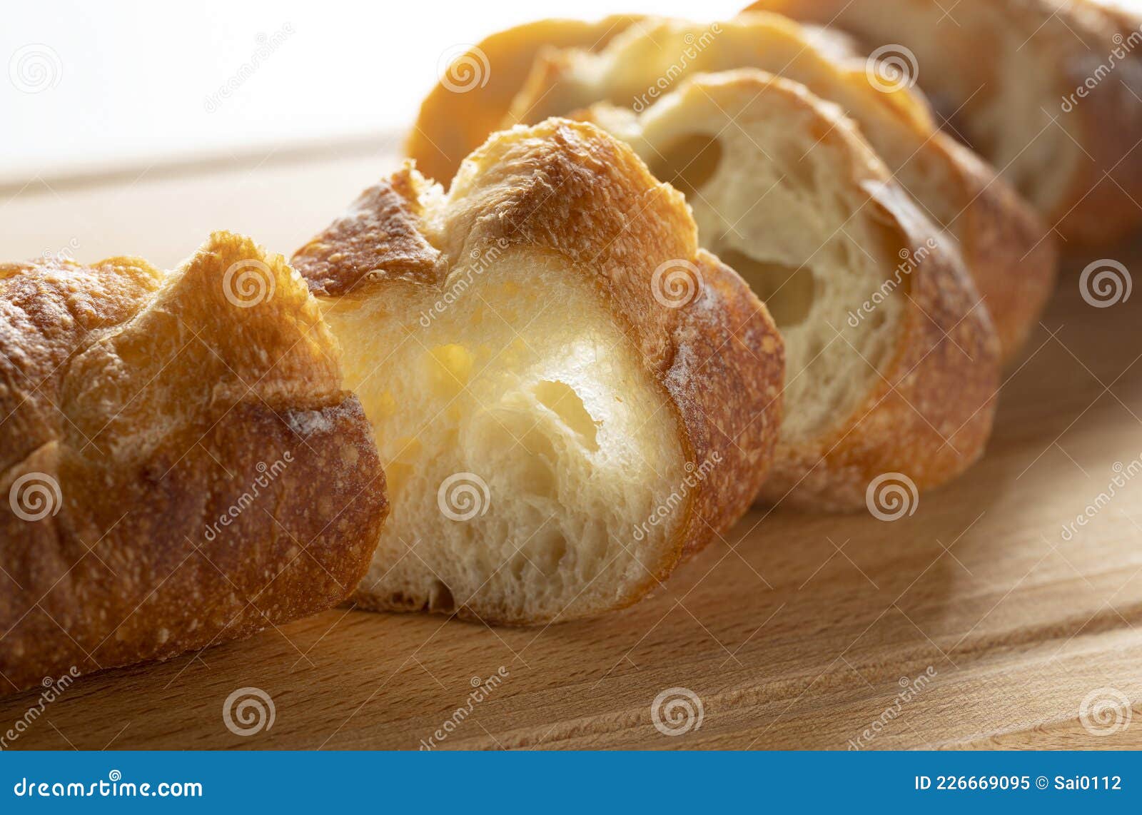 a sliced baguette placed on a cutting board
