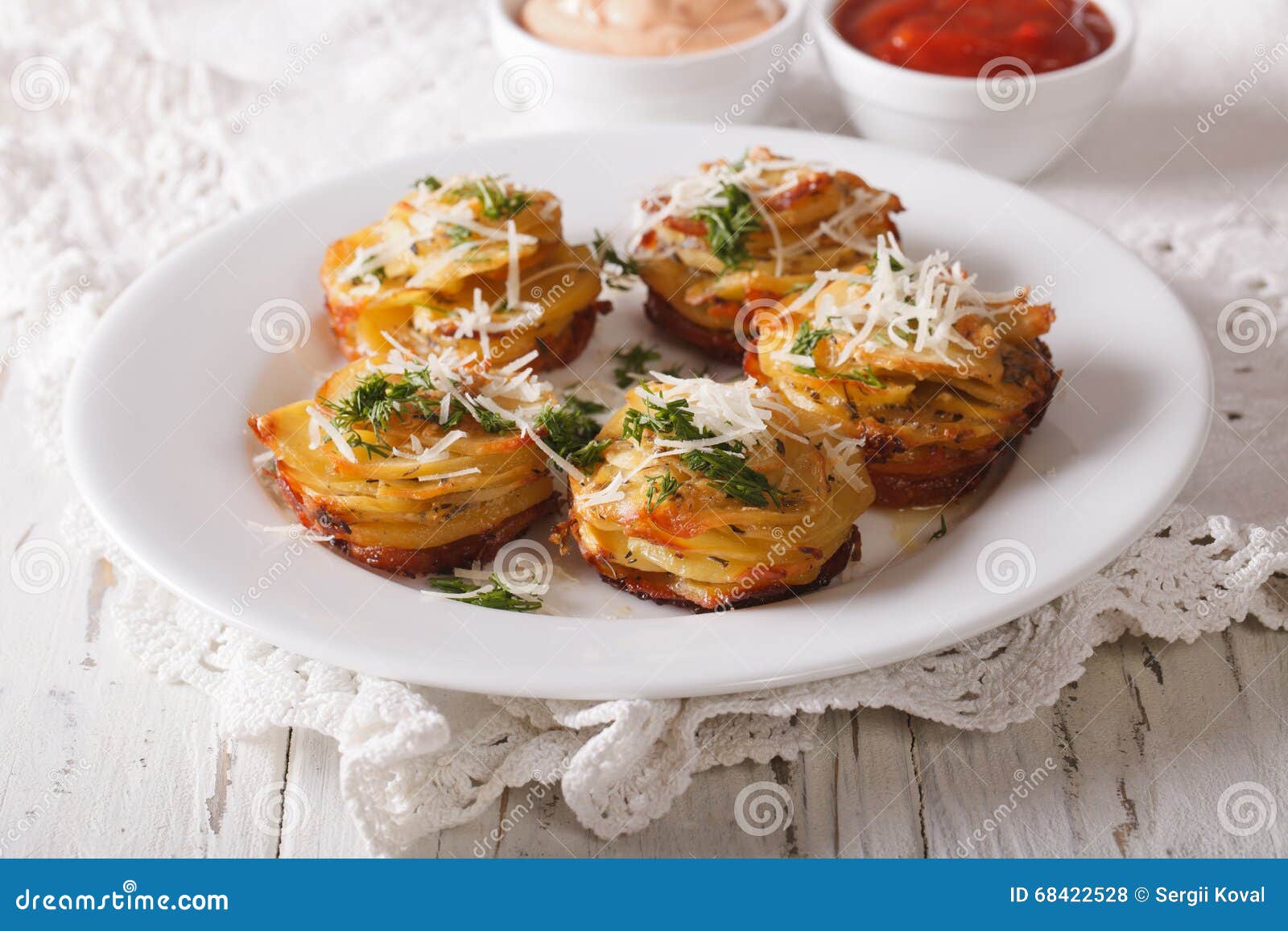 Sliced Baked Potatoes with Parmesan Cheese and Dill Close-up on Stock