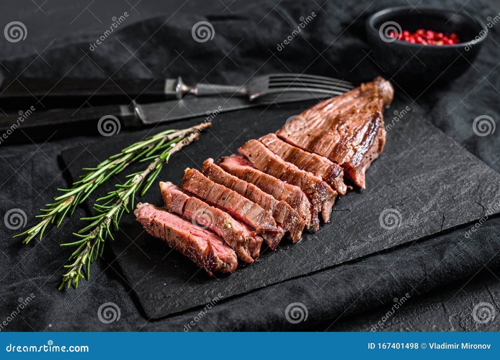 Sliced Beef Flank Steak Medium Rare. Black Background Stock Photo