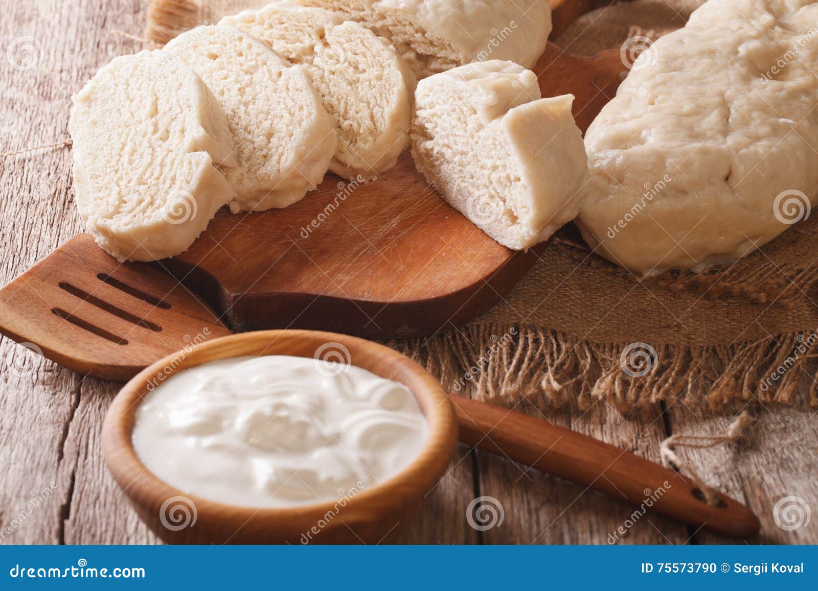 sliced boiled knedle close-up and sour cream. horizontal