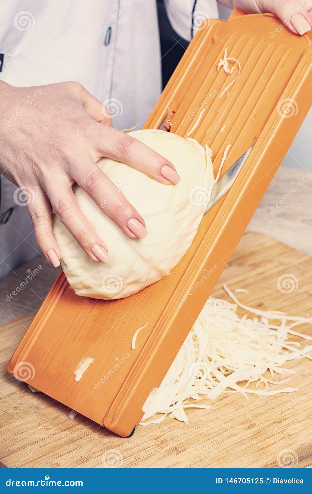 Sliced cabbage on shredder stock image. Image of sauerkraut 146705125