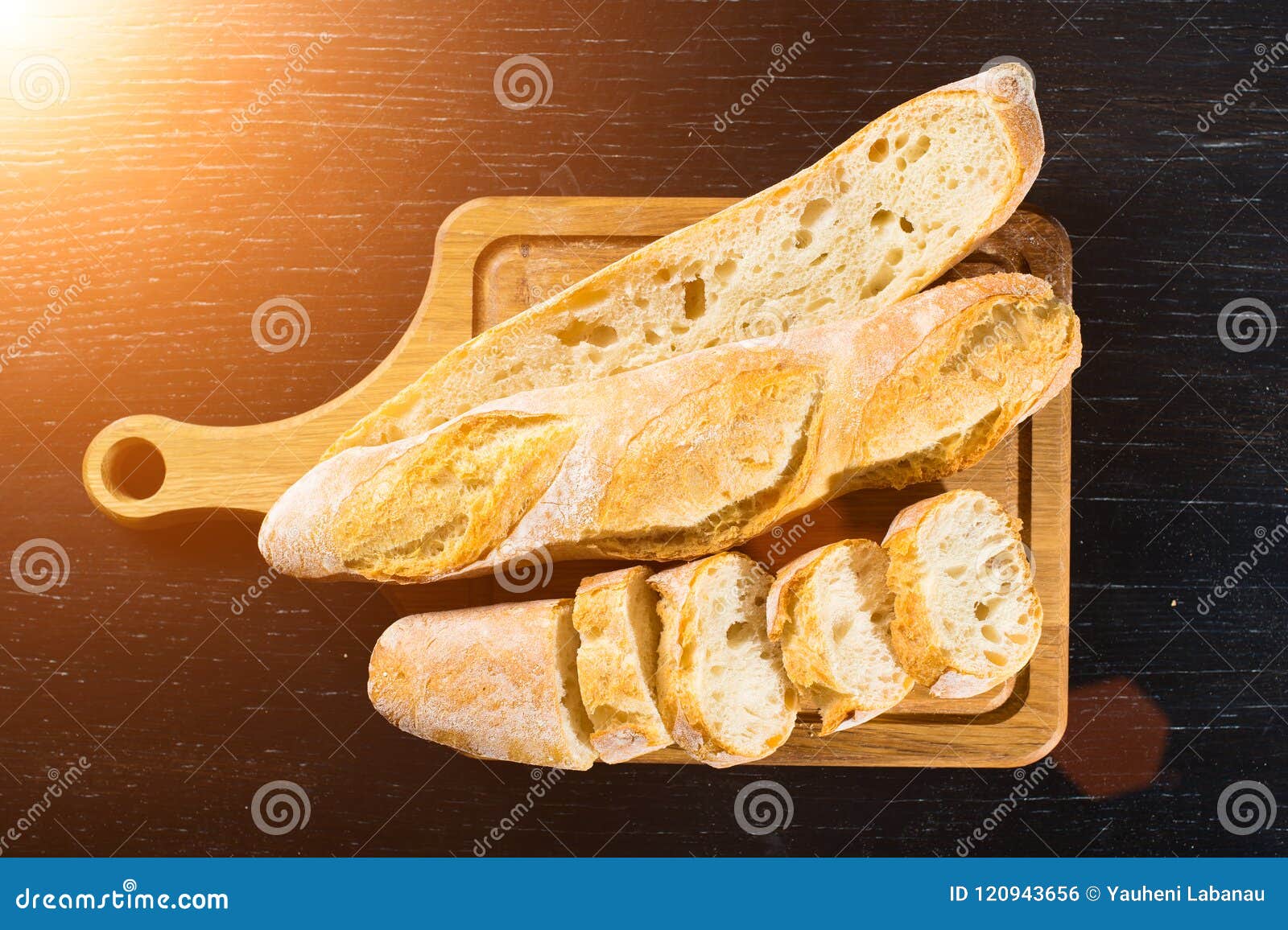 sliced french fresh bread baguette with poolish and on a wooden