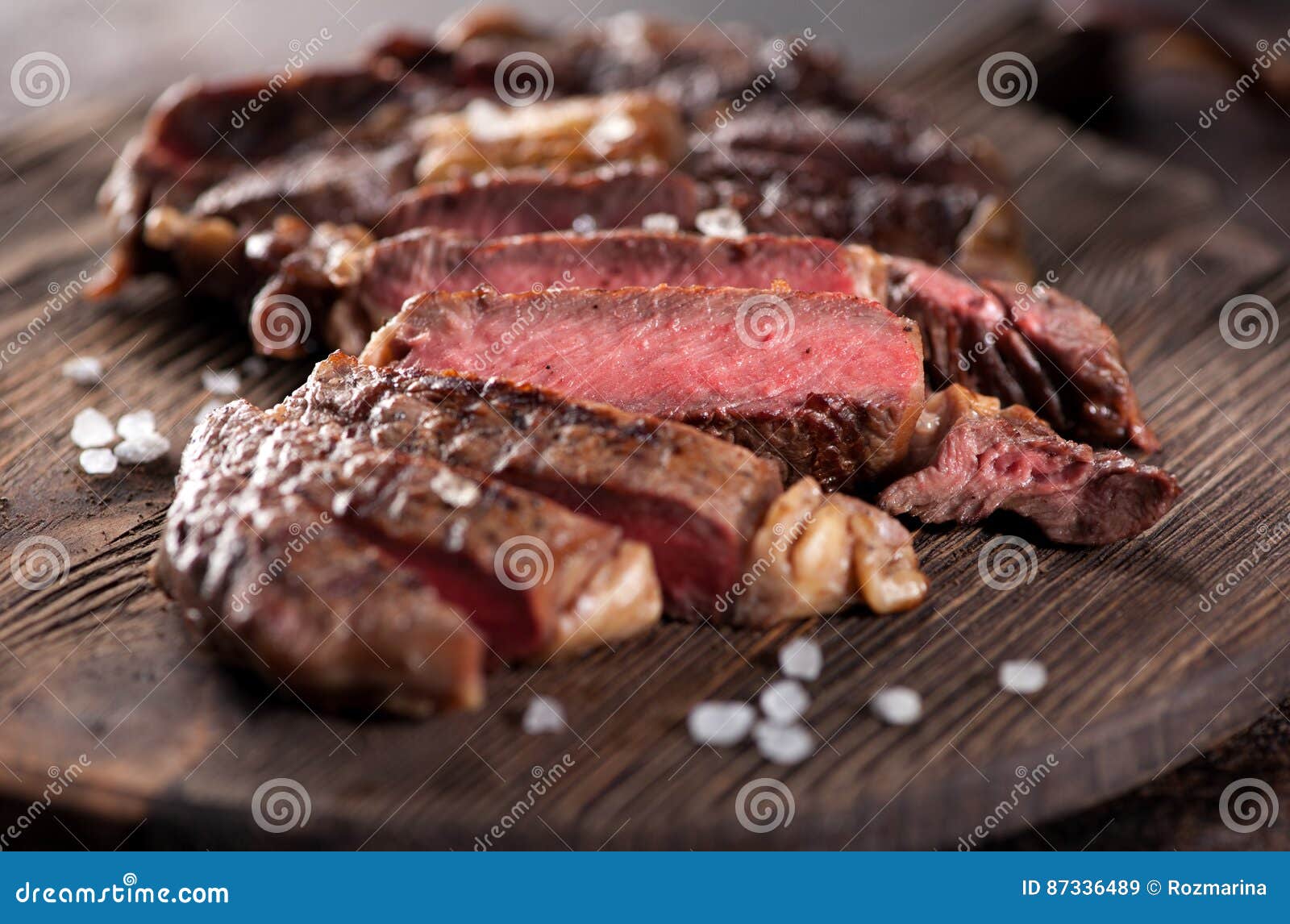 sliced medium rare grilled beef steak ribeye close-up