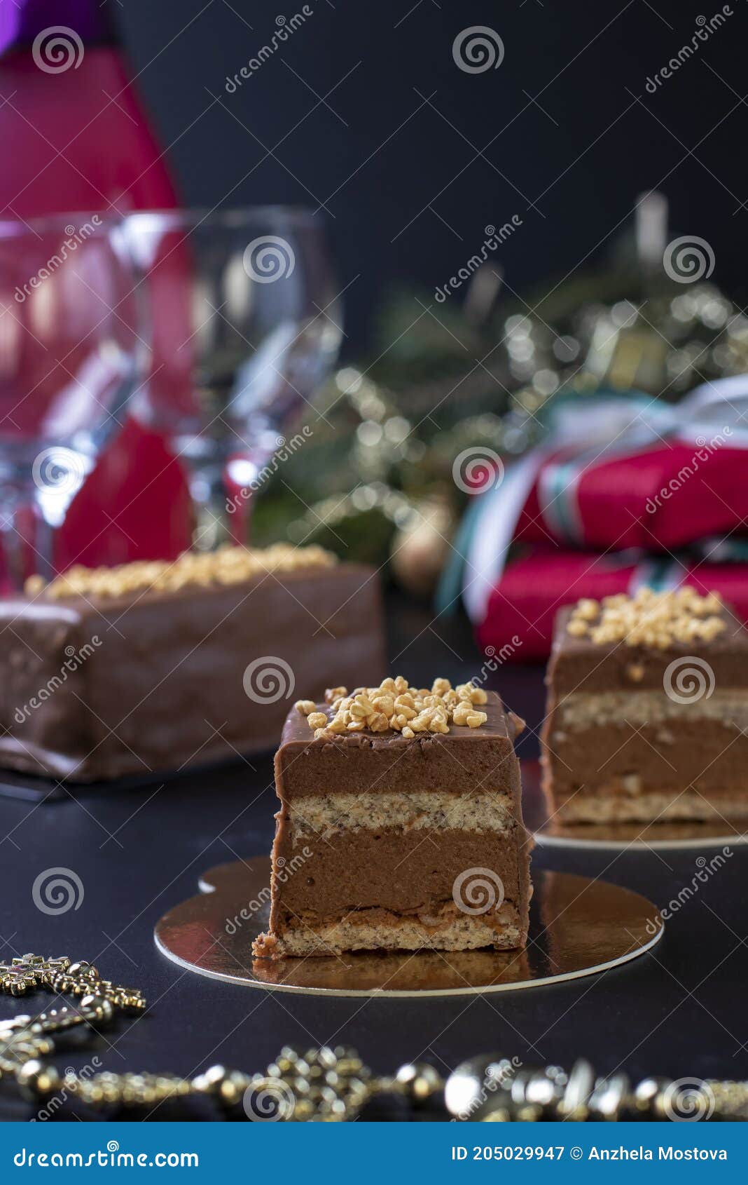 sliced mousse desserts with hazelnut praline, milk chocolate and covered gourmet chocolate-nut glaze on new year background. close