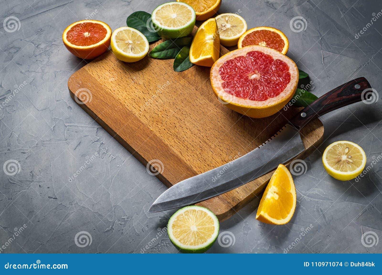 sliced from oranges, grapefruit, lemon, lime slices on a cutting board.
