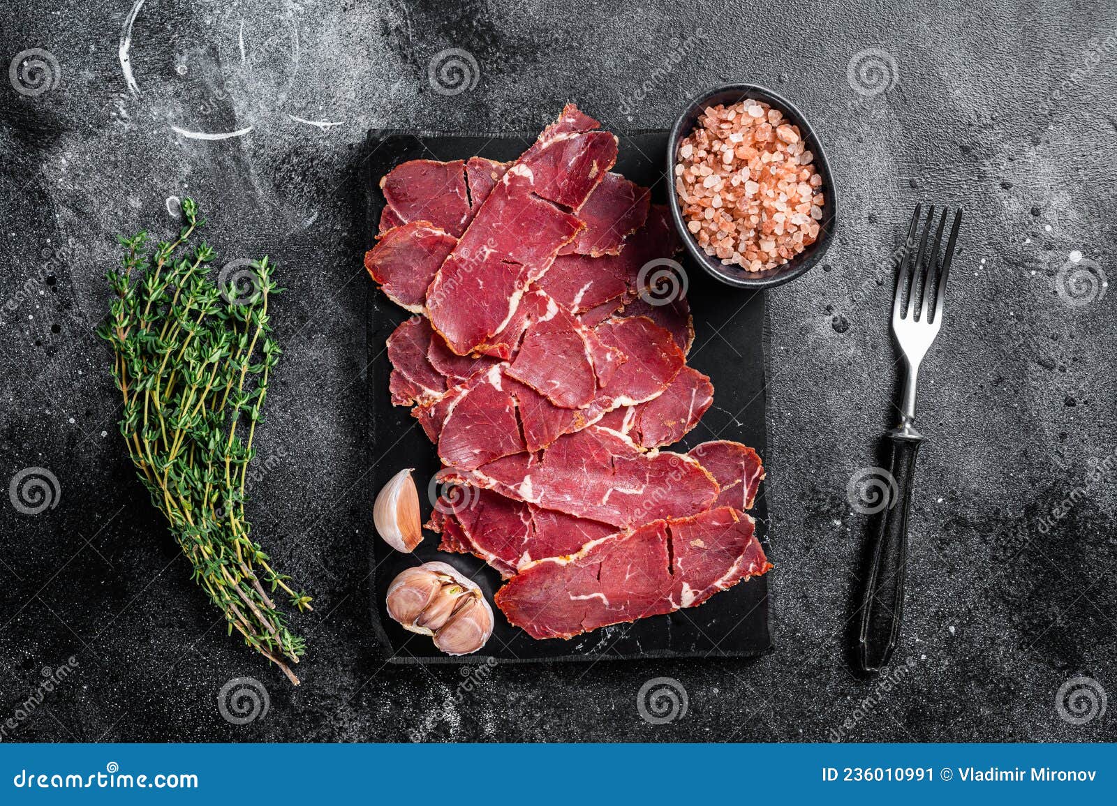 Sliced Pastrami Roasted Beef Meat with Herbs. Black Background Stock