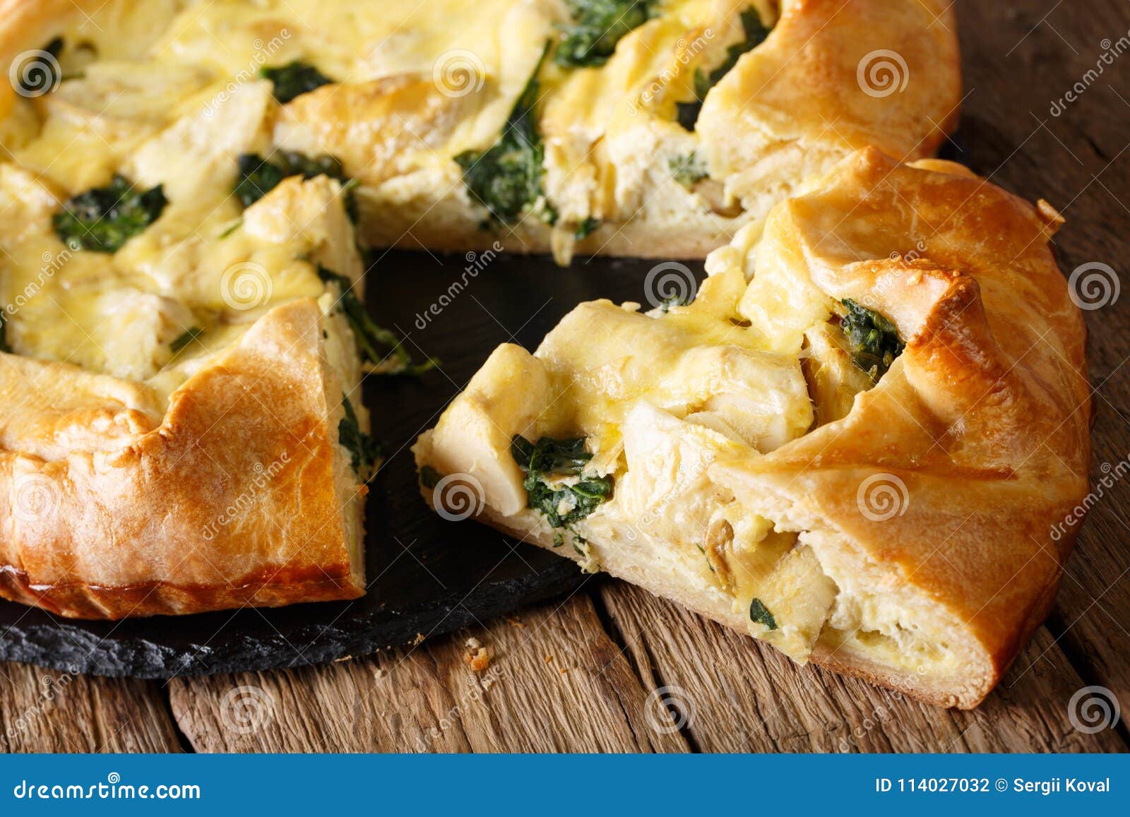 Sliced Pie with Artichokes, Cheese and Spinach Closeup. Horizon Stock