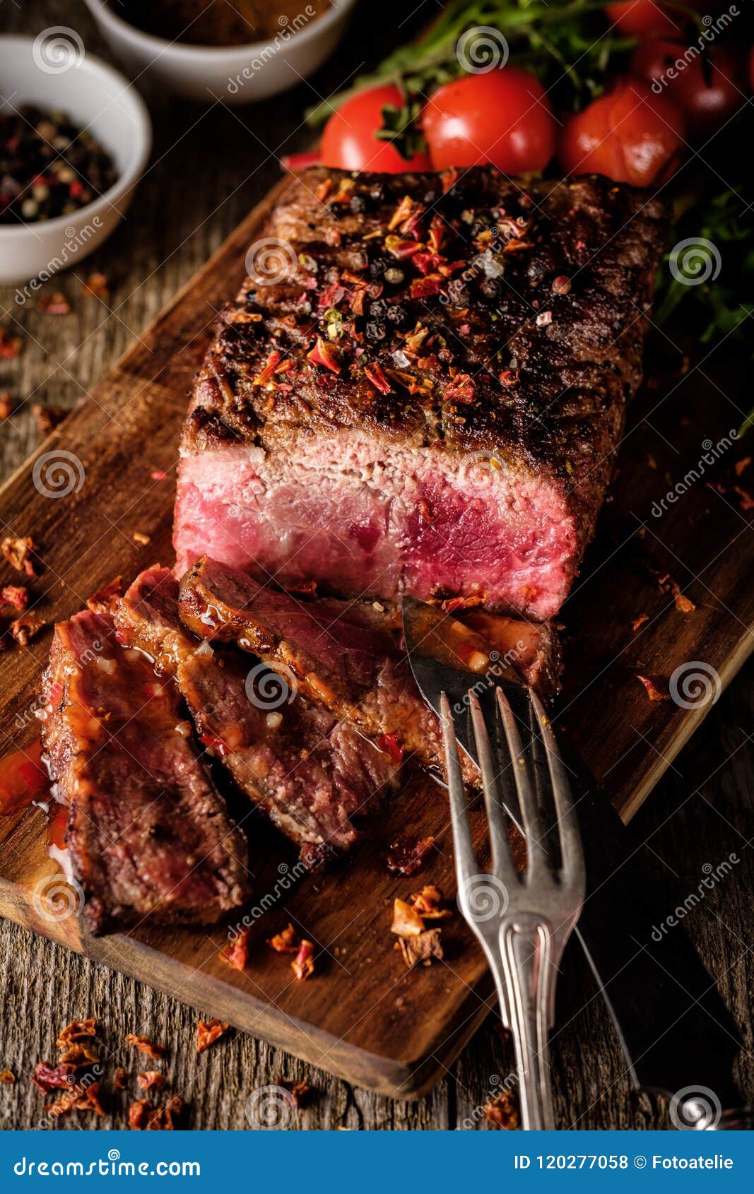 Sliced Roast Beef on Cutting Board with Grilled Vegetables . Stock