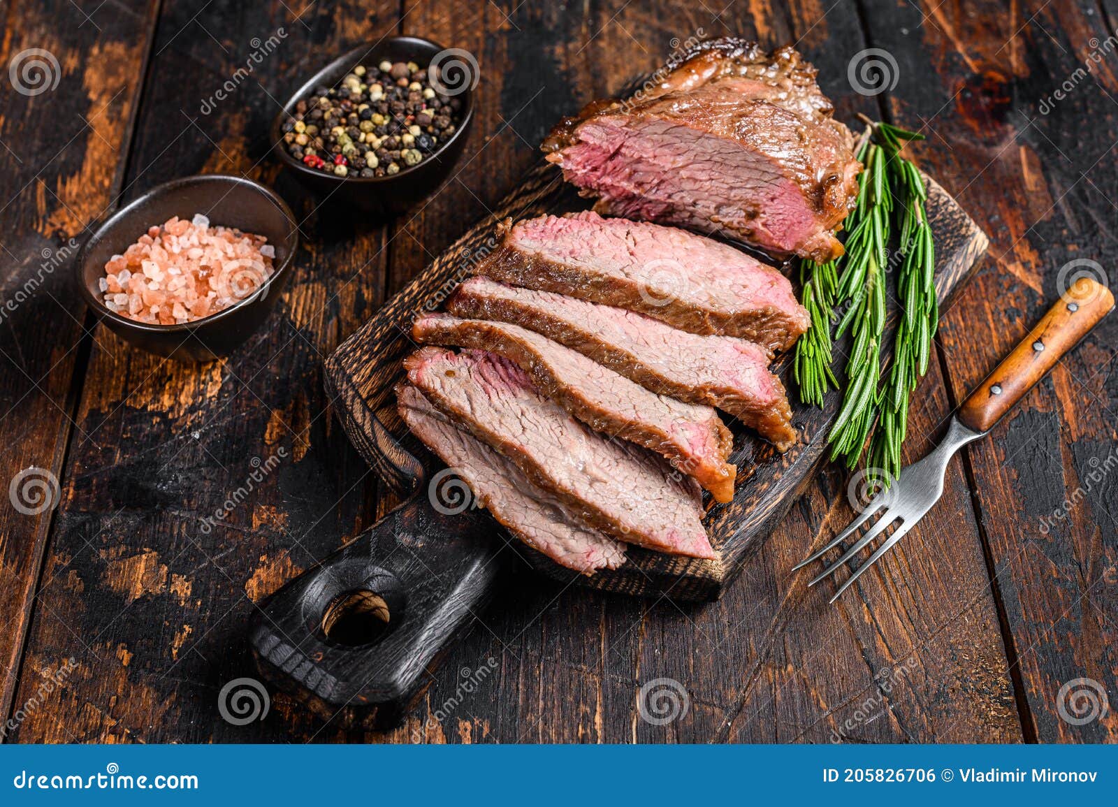 sliced roast beef sirloin tri tip steak bbq. dark wooden background. top view