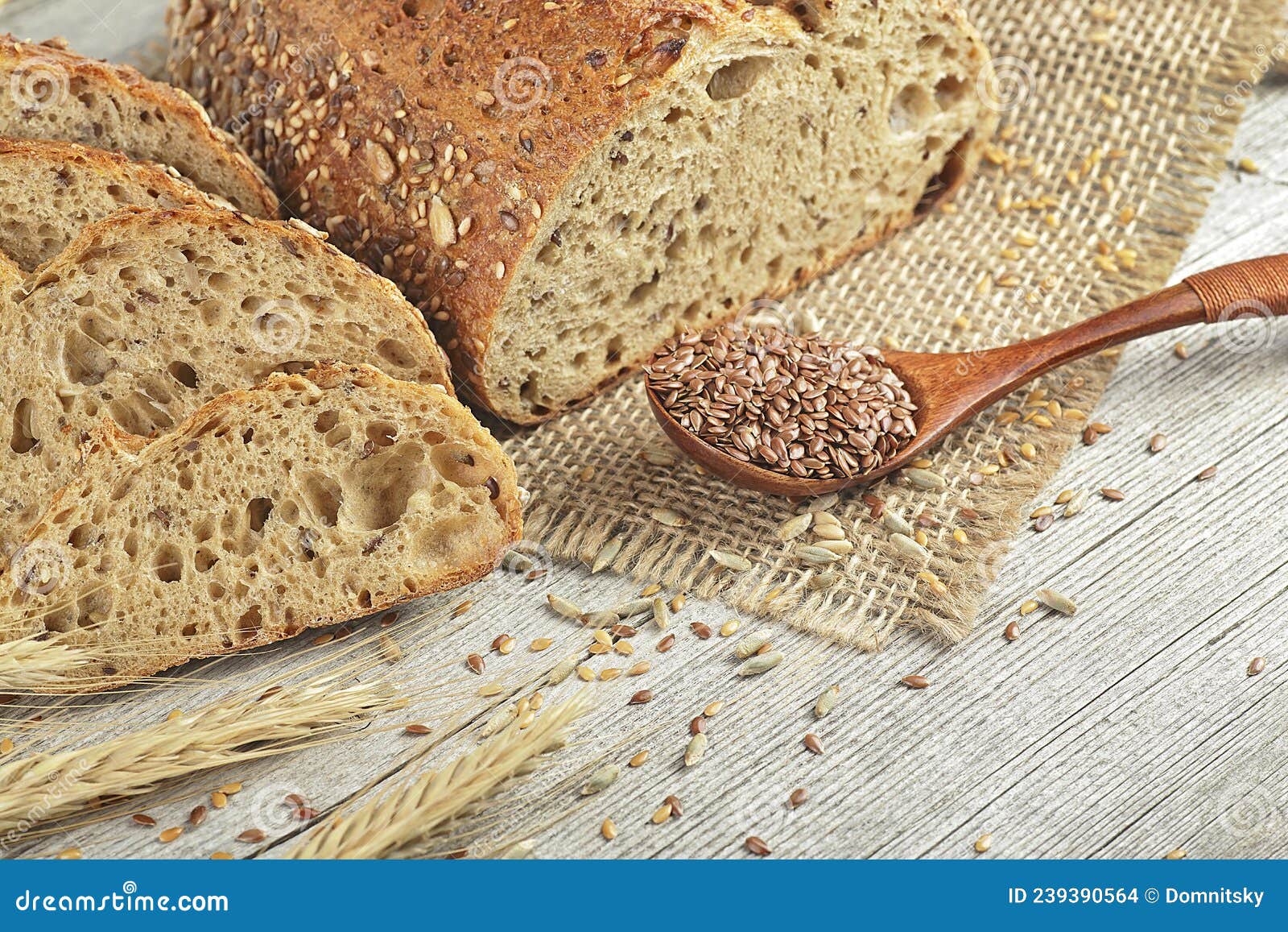 Sliced Rye Bread on Rustic Board. Whole Grain Rye Bread with Seeds and Spikelets Stock Photo