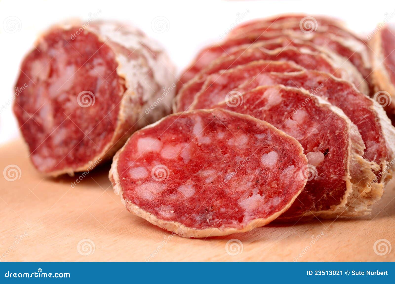 Sliced Salami Smoked Sausage, Basil Leaves And Peppercorns, Isolated On White Background Royalty