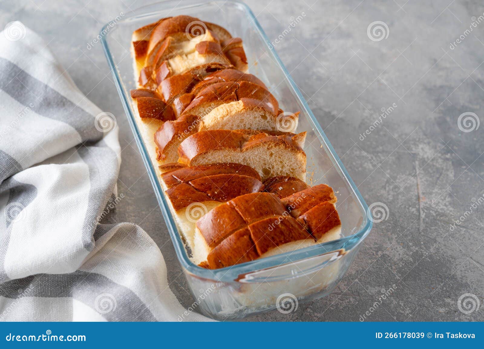 Sliced Sweet Bread in a Baking Dish on a Gray Concrete Background