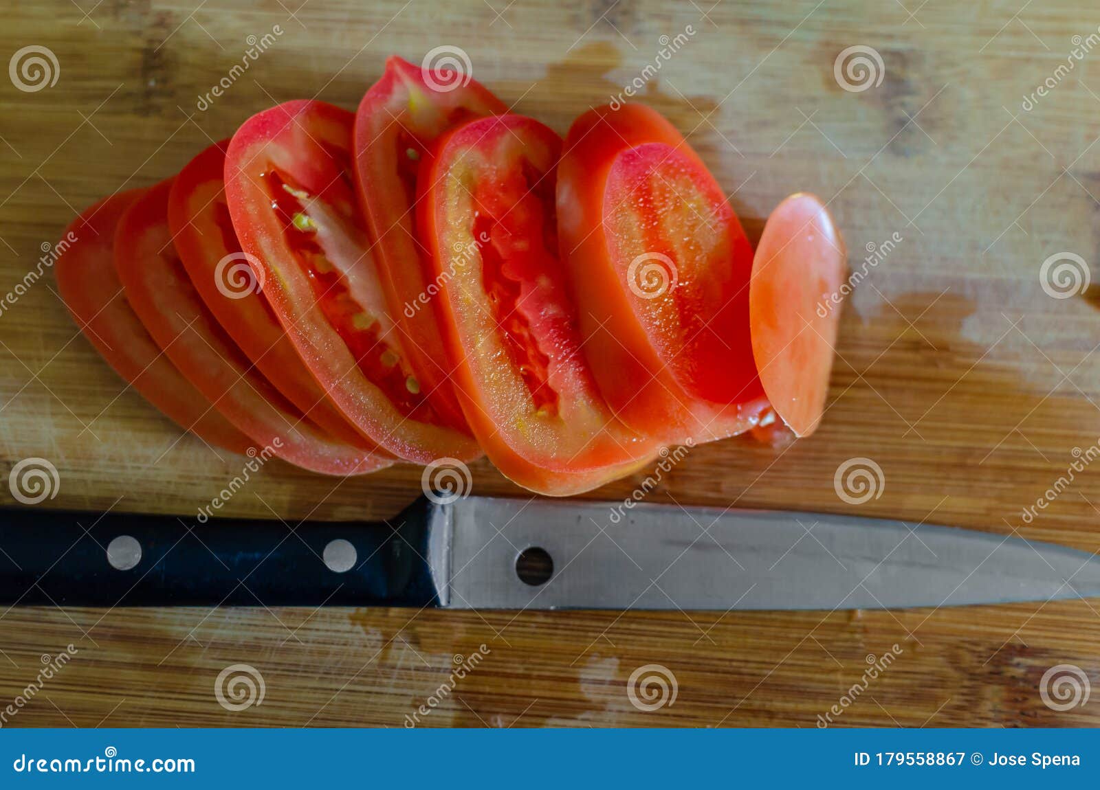 Sliced tomatoe and knife stock image. Image of aliments 179558867