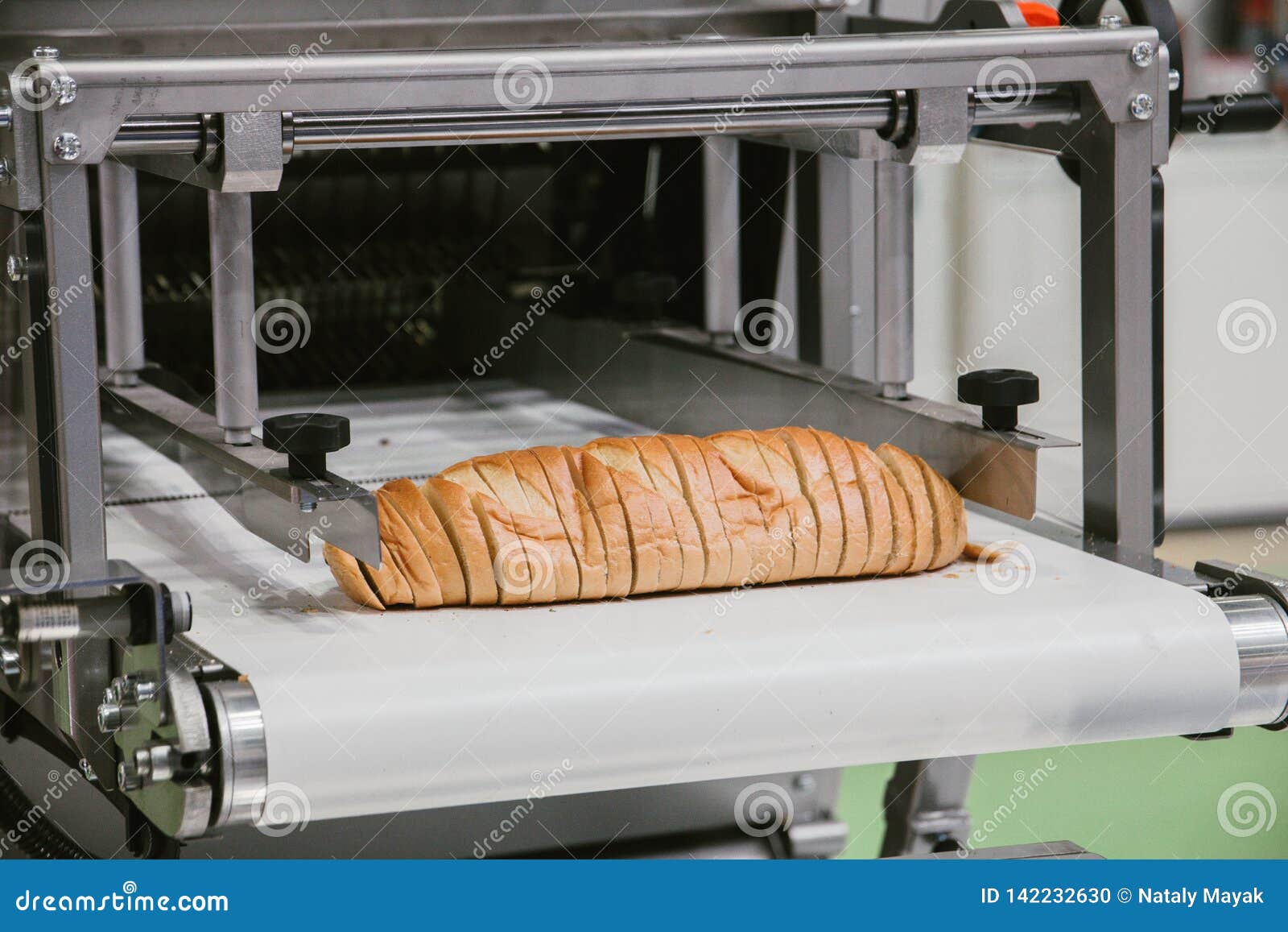 Sliced White Bread in Cutting Machine, Baking Equipment Selective Focus