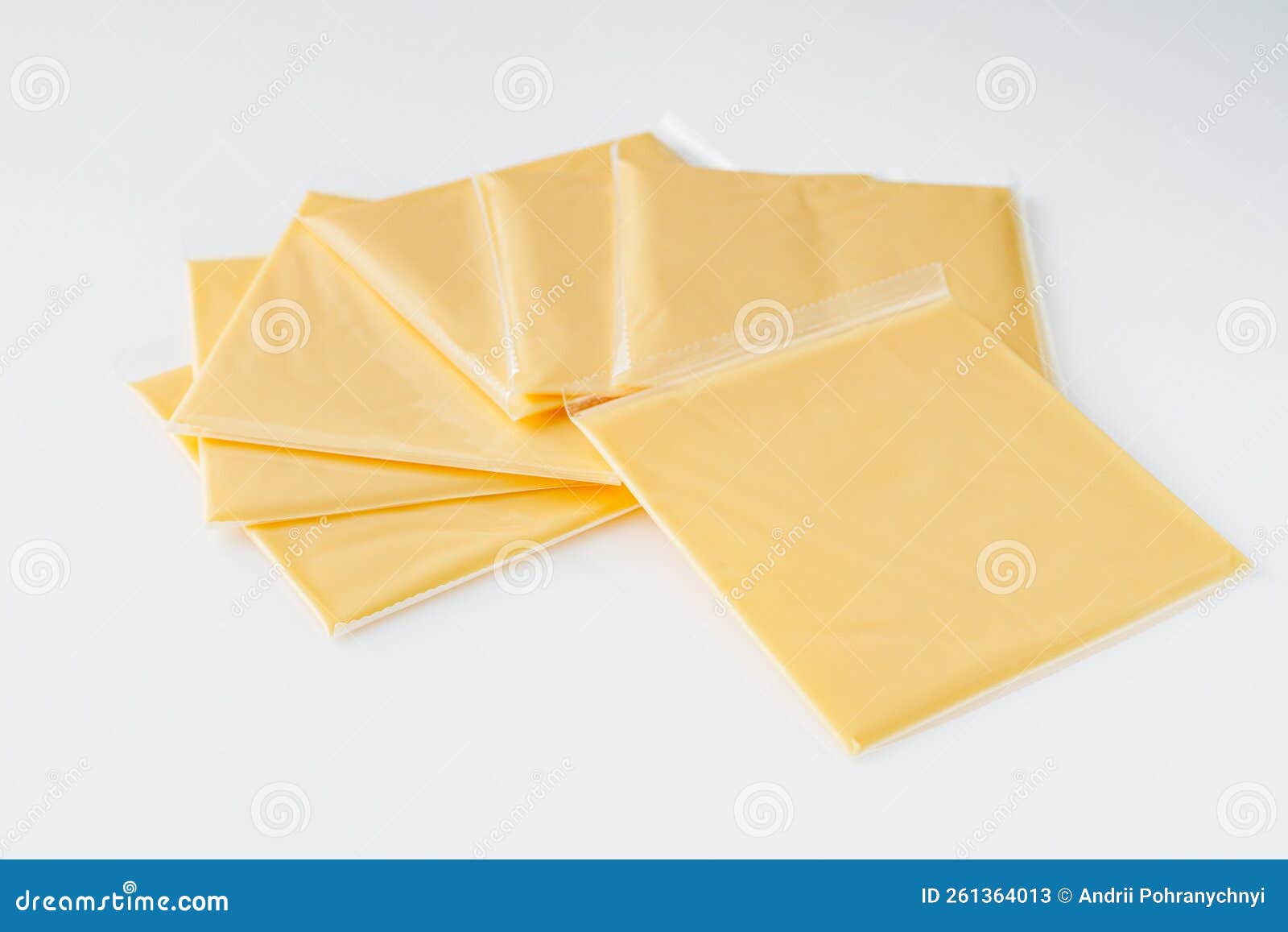 Slices of American Cheddar Cheese on a White Background Stock Image