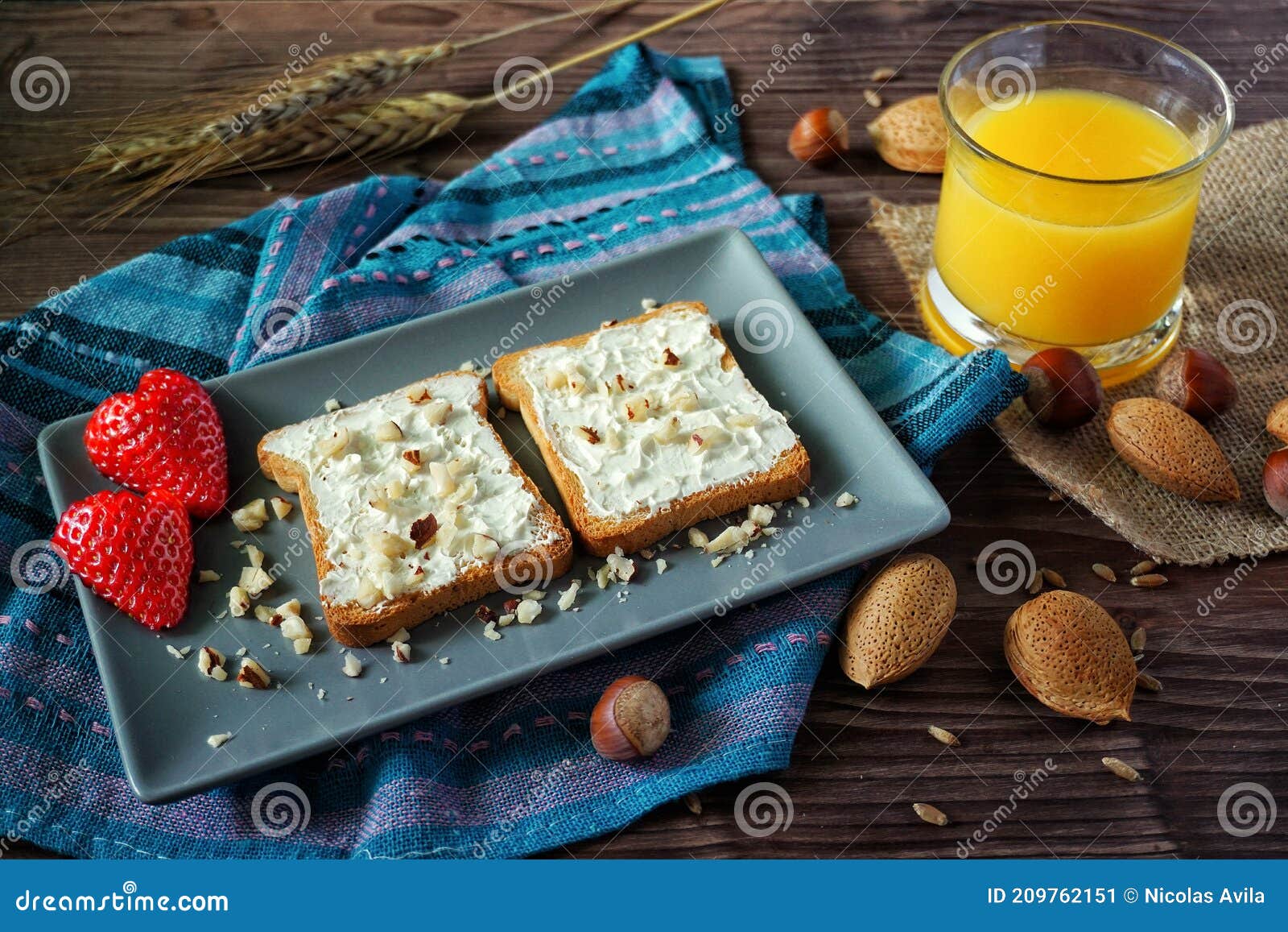 slices of bread with cream cheese, strawberries and juice
