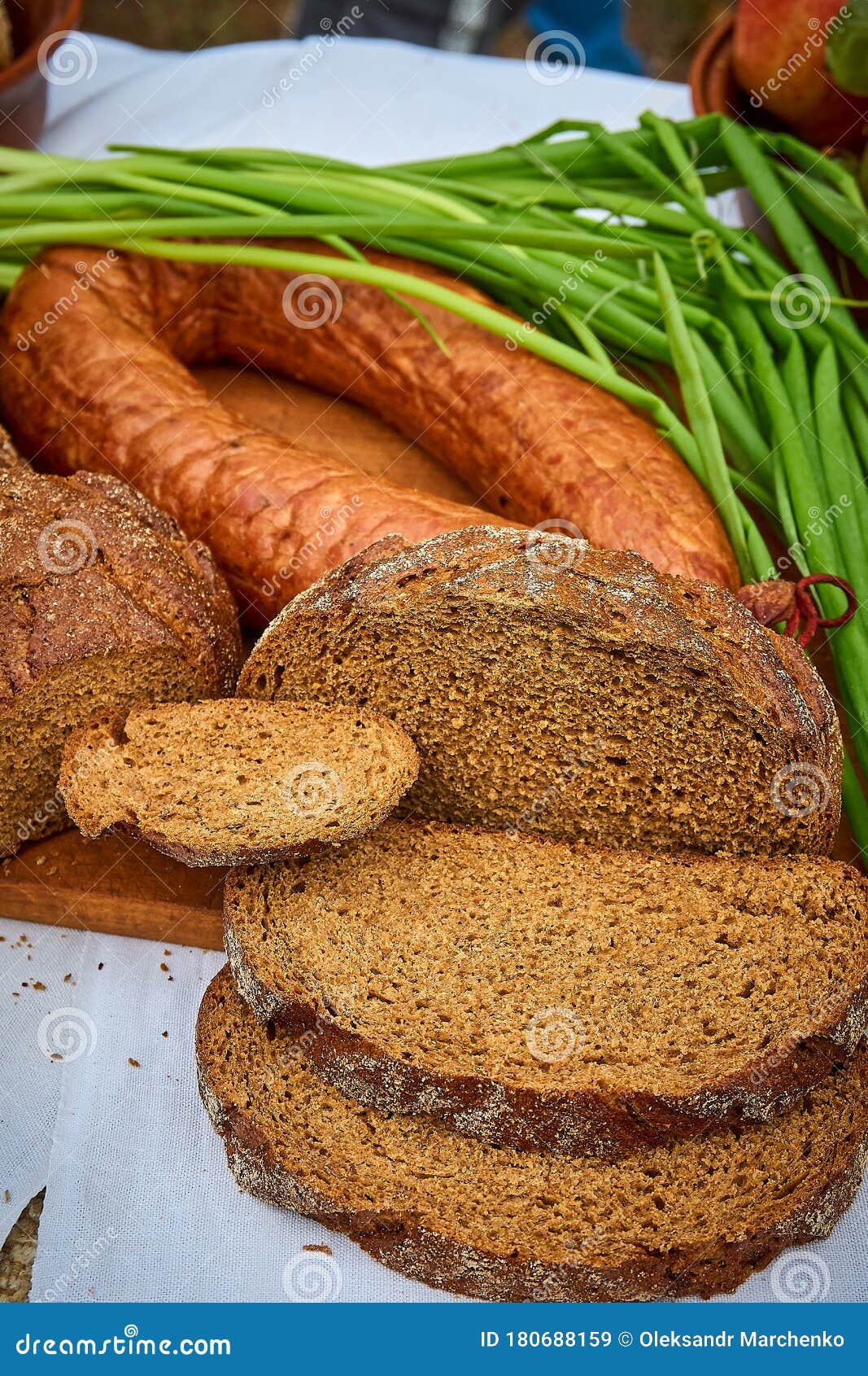 Slices of Bread, Sausage Ring and Green Onions on the Table Stock Image
