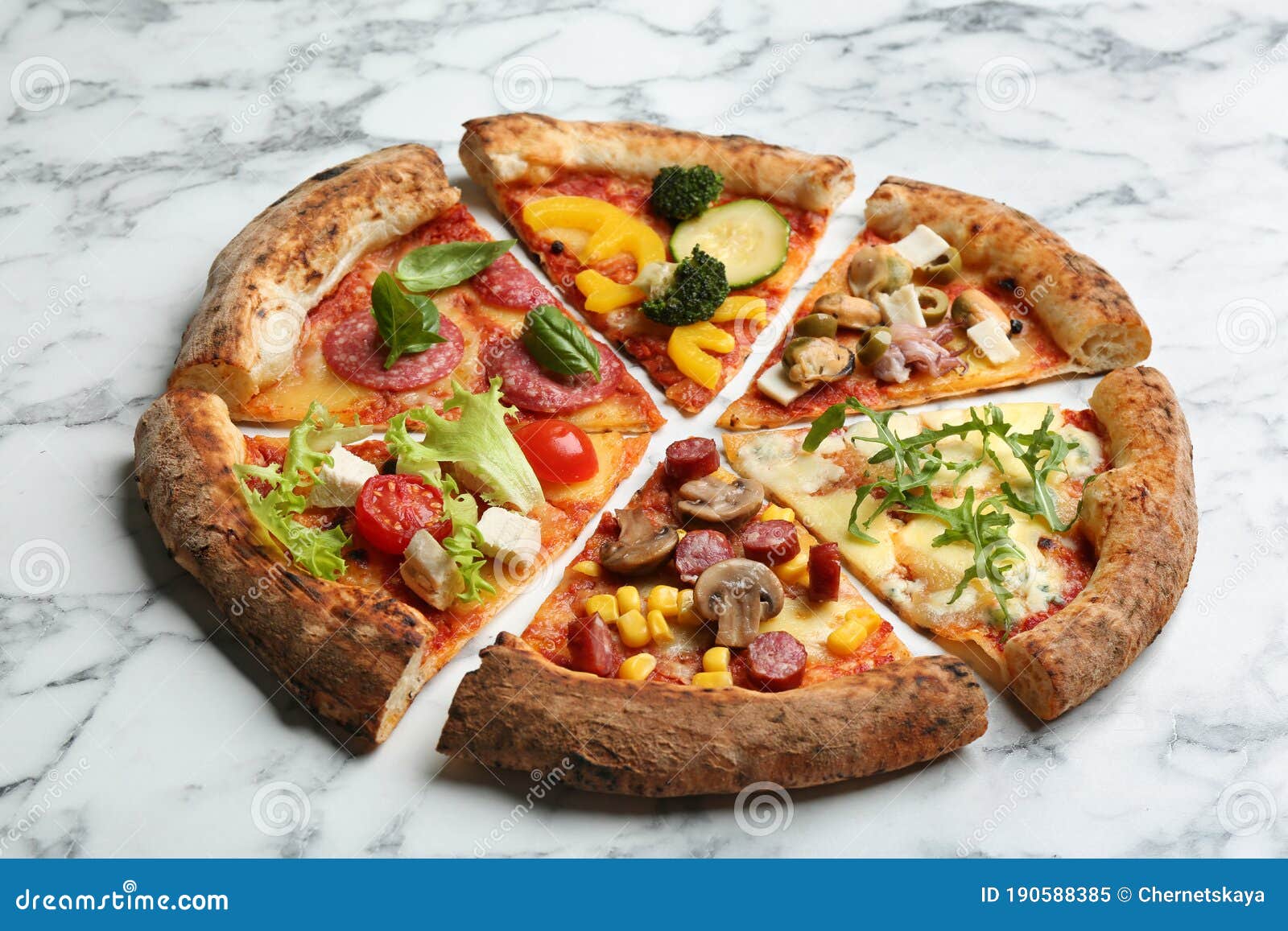 Slices of Different Delicious Pizzas on Marble Table Stock Image