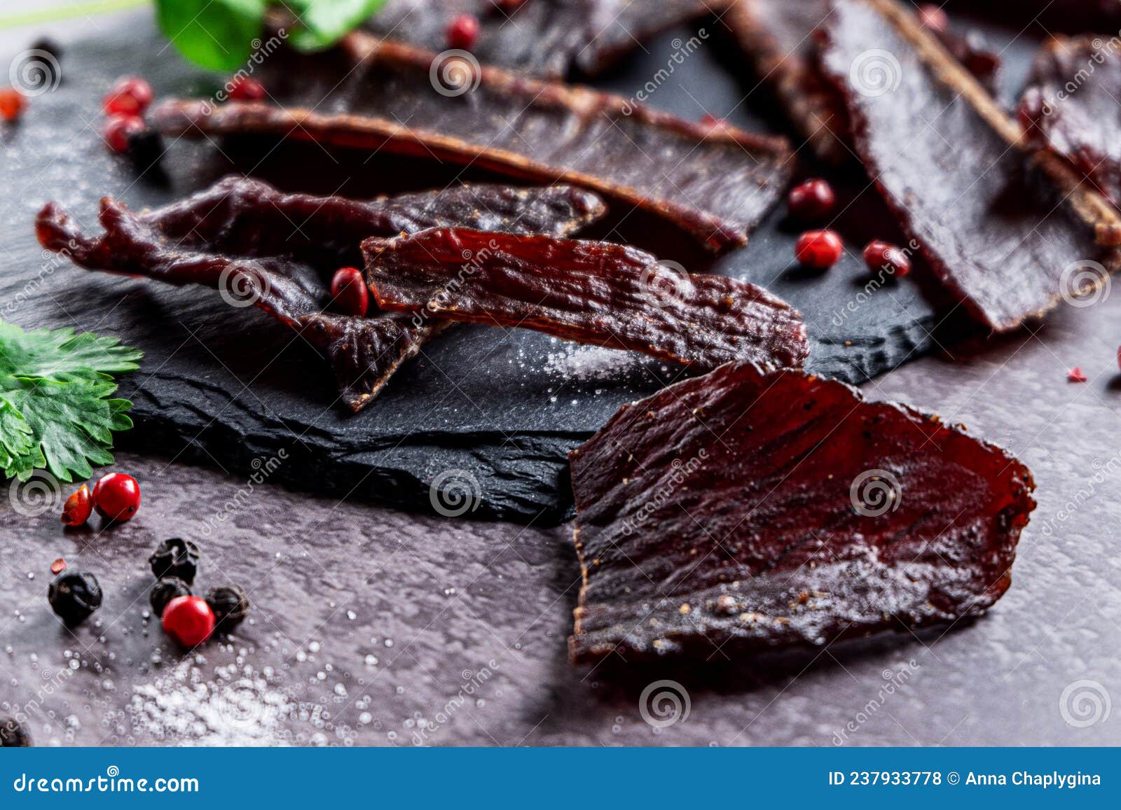 slices of jerky meat on a dark backdround