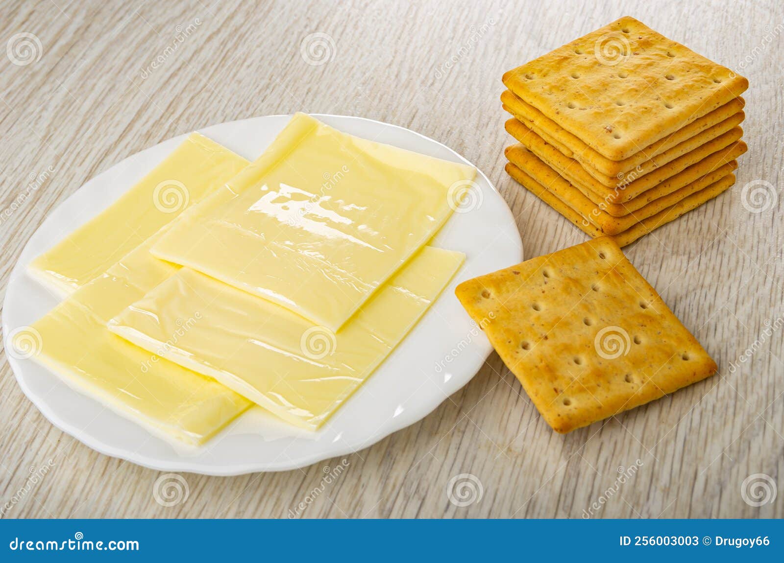 Slices of Melted Cheese in Plate, Stack of Crackers on Table Stock Image Image of table
