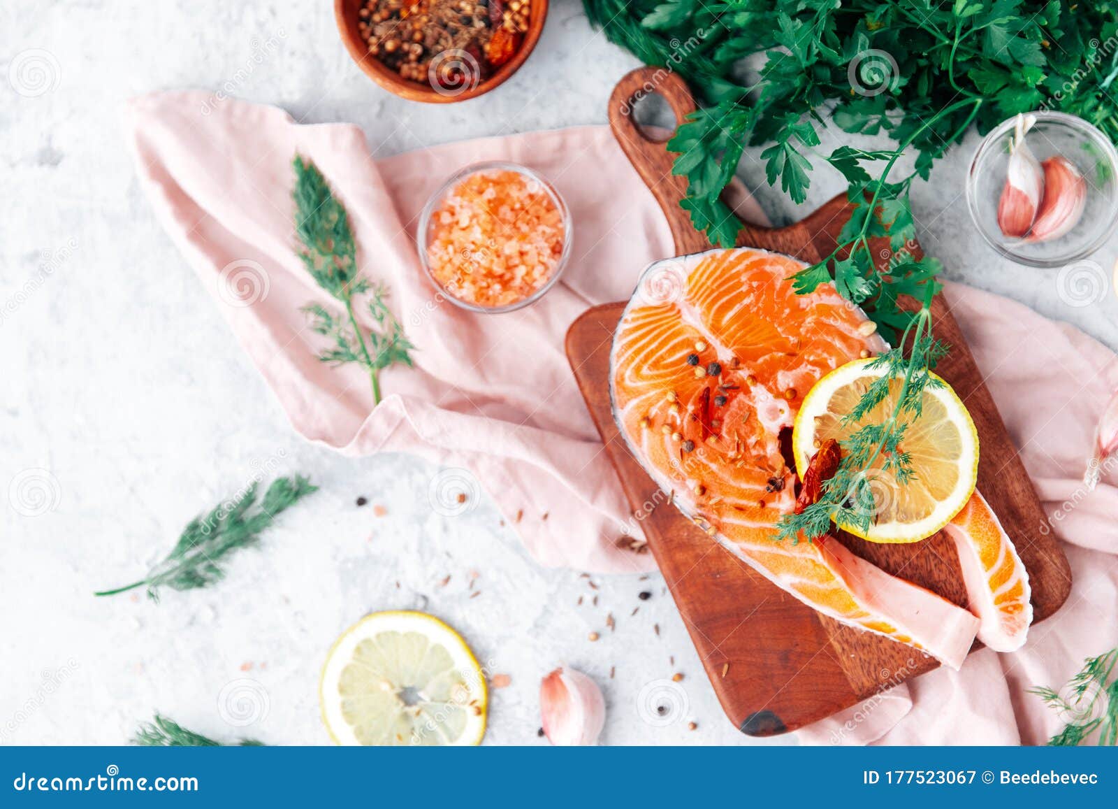 slices of red fish with rosemary branch,  on the cutting board