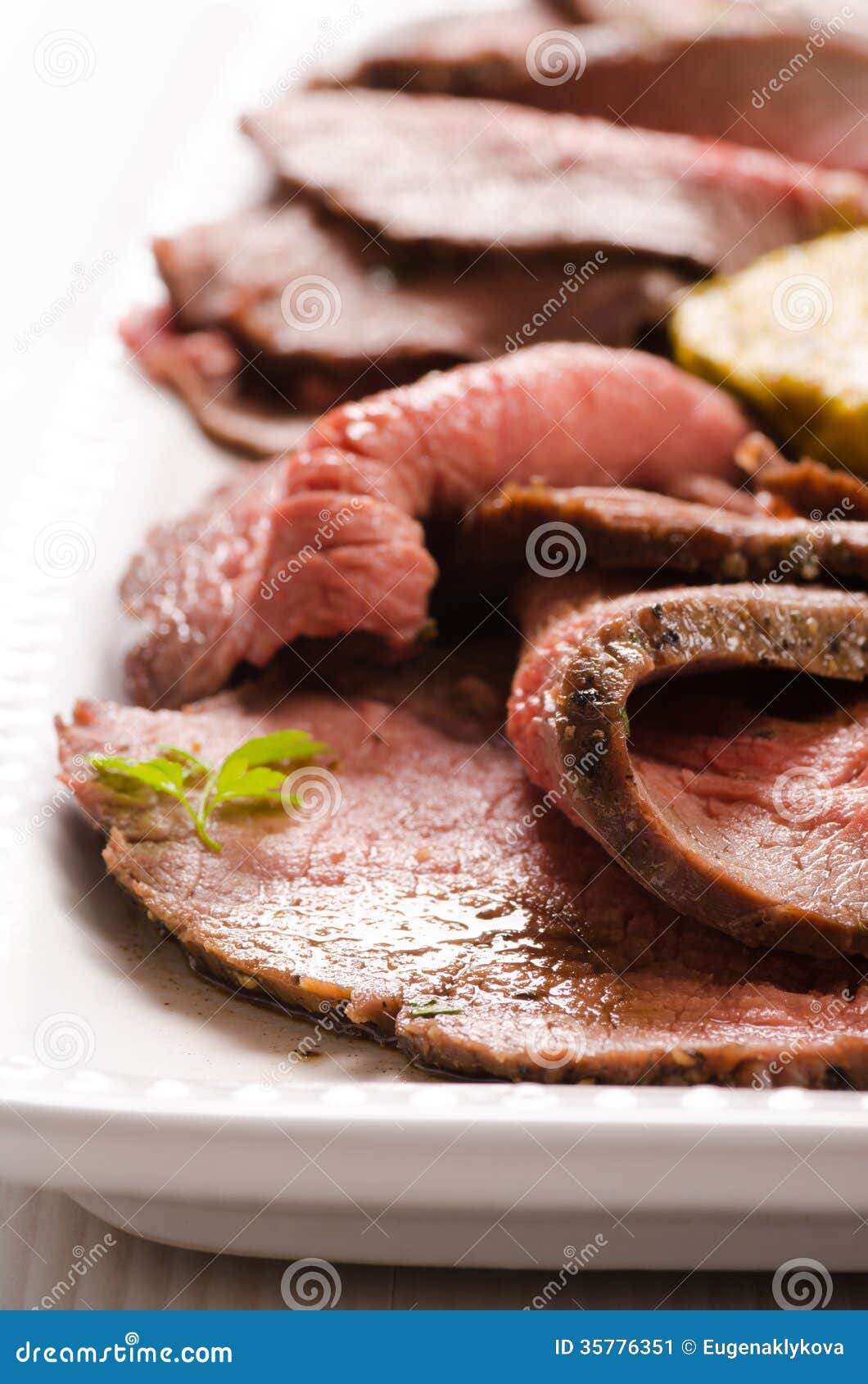 Slices of roast beef on serving plate. Slices of roastbeef on serving plate. Selective focus.