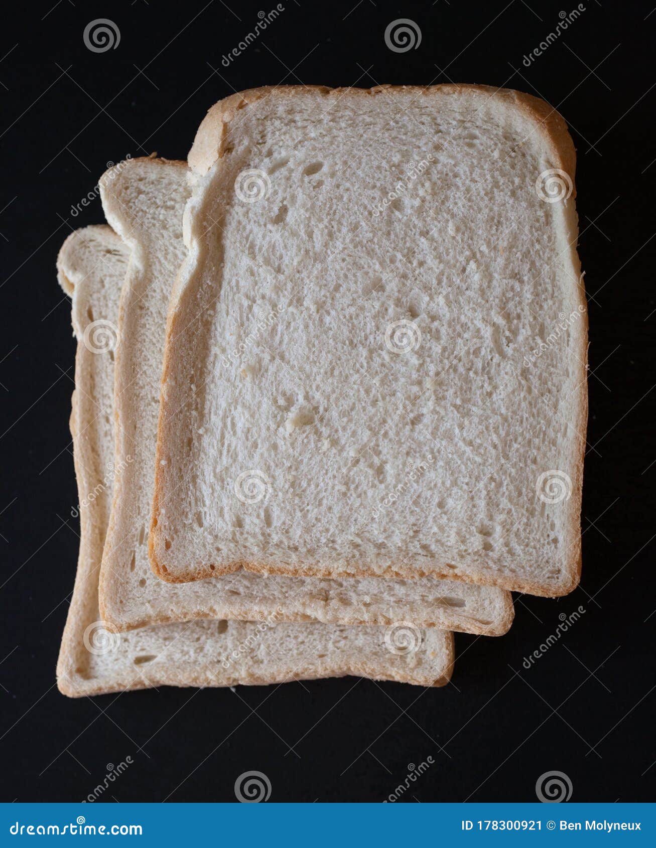 slices of white bread on a black background