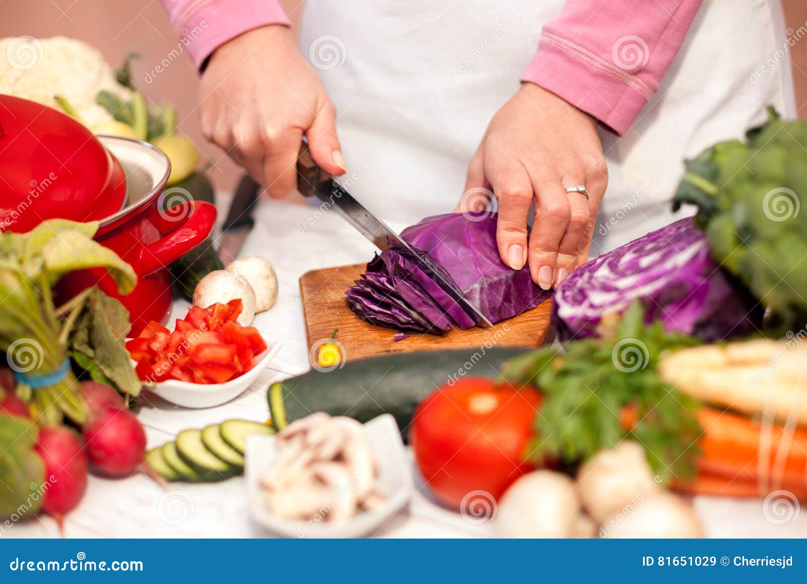 Slicing of Red Cabbage on Chopping Board with a Knife Stock Image