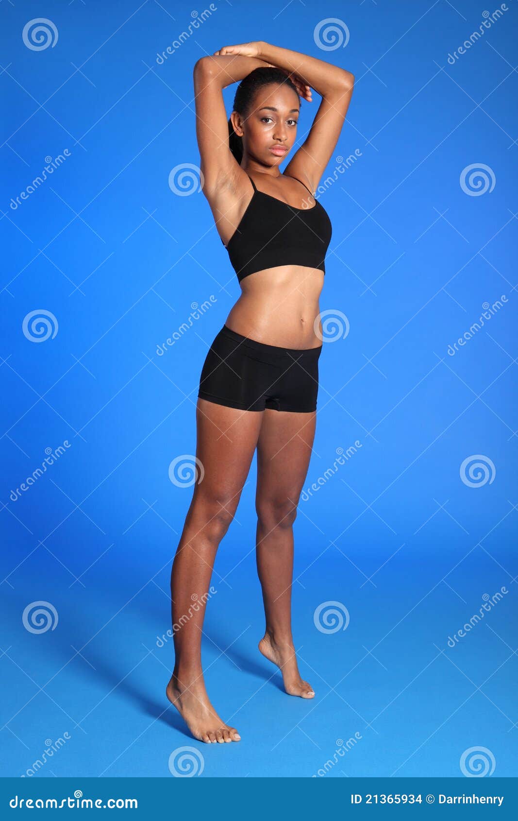 Afro-American skinny woman wearing lingerie with arms crossed