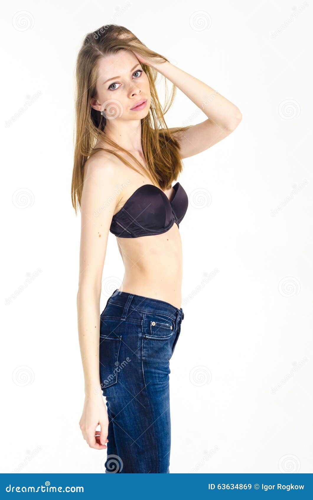 Slim Blonde Girl with Long Hair in Jeans and Black Bra Stock Image