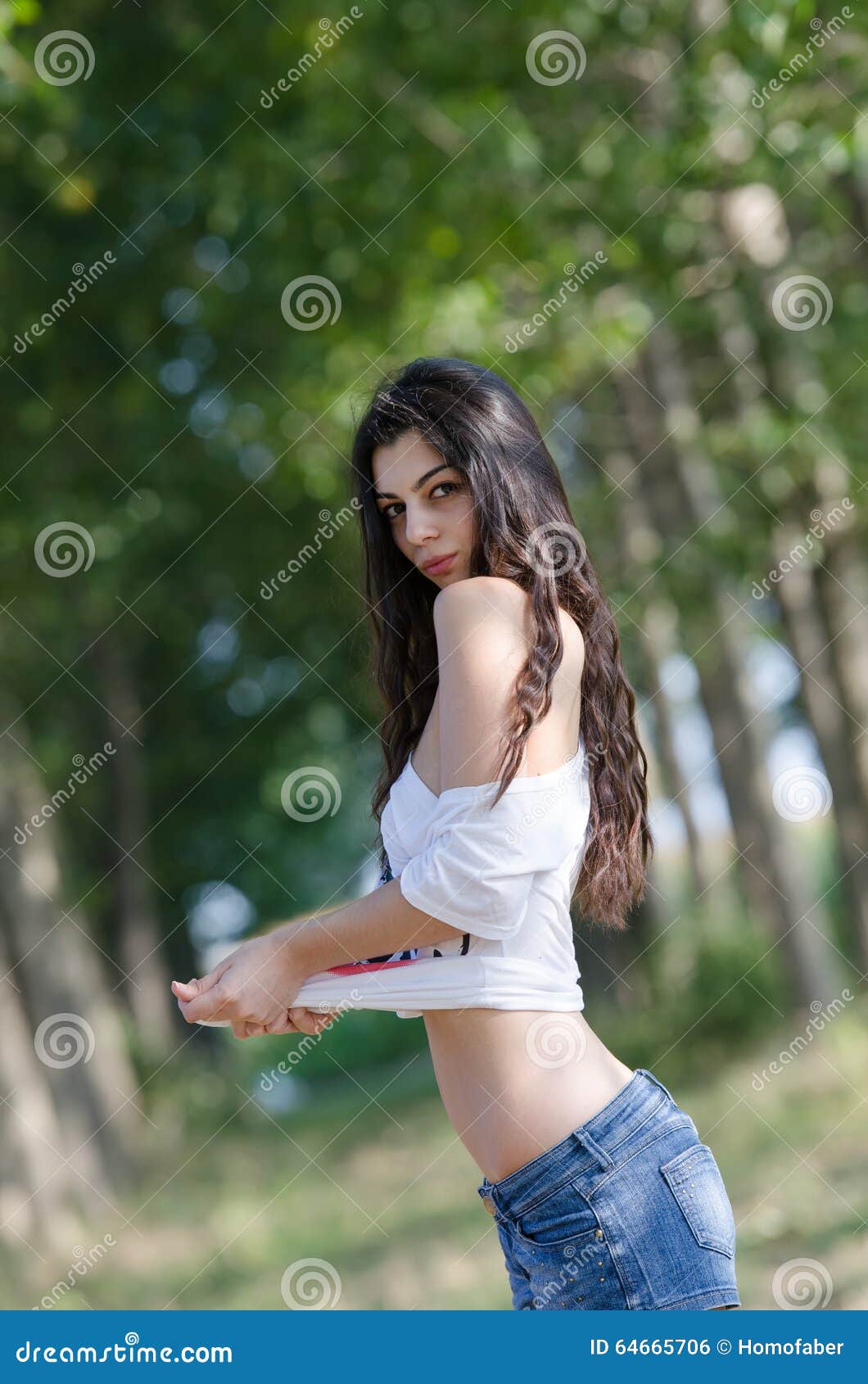 Slim Brunette Lady with Long Hair Playing with Her Shirt and Reveals Her  Flat Belly Stock Photo - Image of female, fashion: 64665706